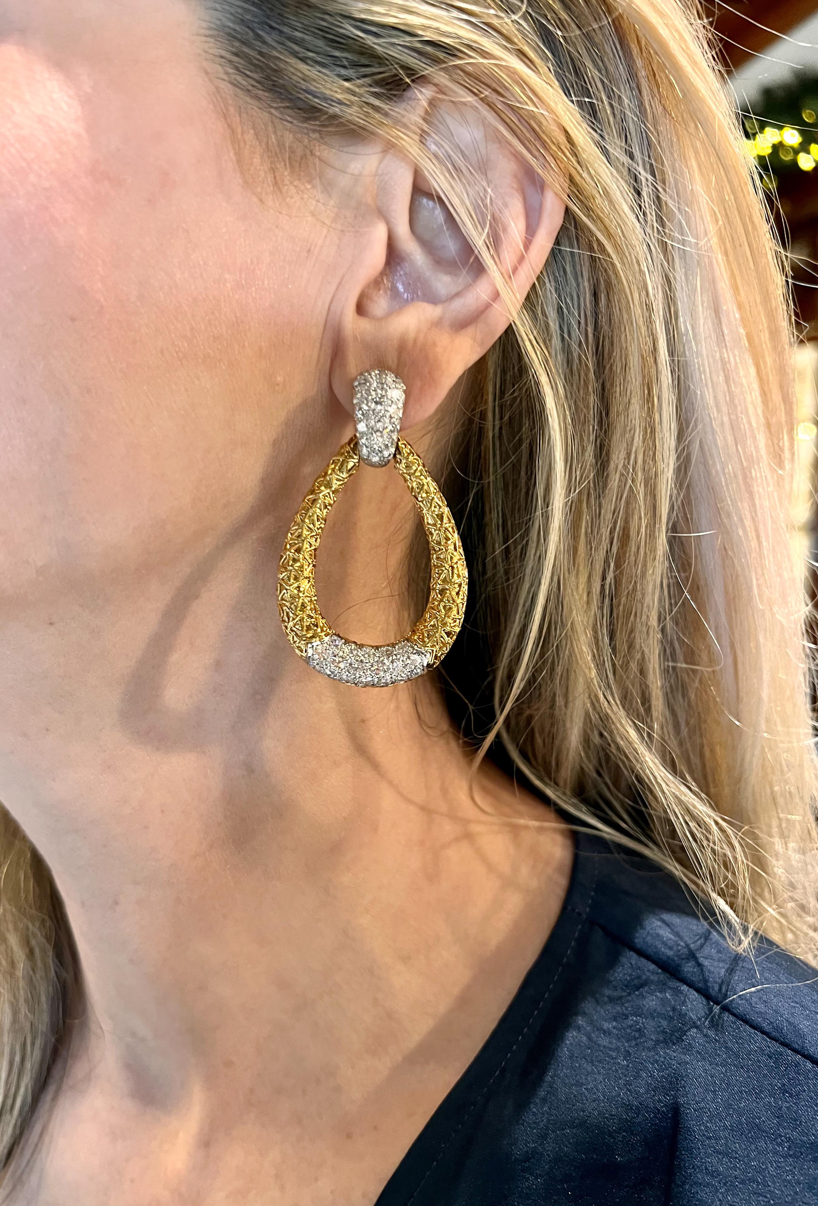 Van Cleef & Arpels large door knocker earrings, featuring platinum pierced clip tops, each pave-set with nineteen round brilliant-cut diamonds, as well as 18k yellow gold textured, tear drop pendant bottoms, each pave-set with eighteen round