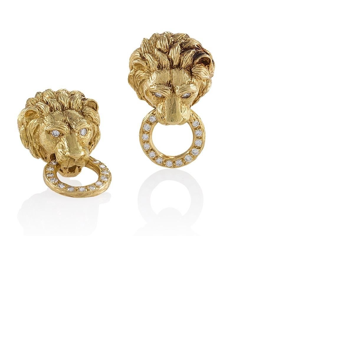 A pair of Mid-20th Century 18 karat gold lion head earrings with diamonds by Van Cleef & Arpels. The earrings have 30 round diamonds with an approximate total weight of 1.50 carats. The earrings are designed as a lion mask supporting a diamond set