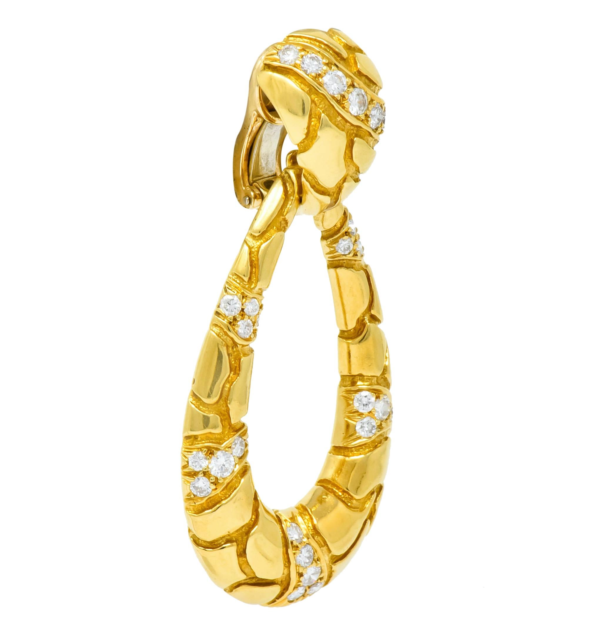Ear-clips designed as triangular surmounts with large, removable drops featuring a polished gold finish with recessed cracked motif

Bead set throughout with round brilliant diamonds weighing approximately 2.00 carat total, F/G color and VS