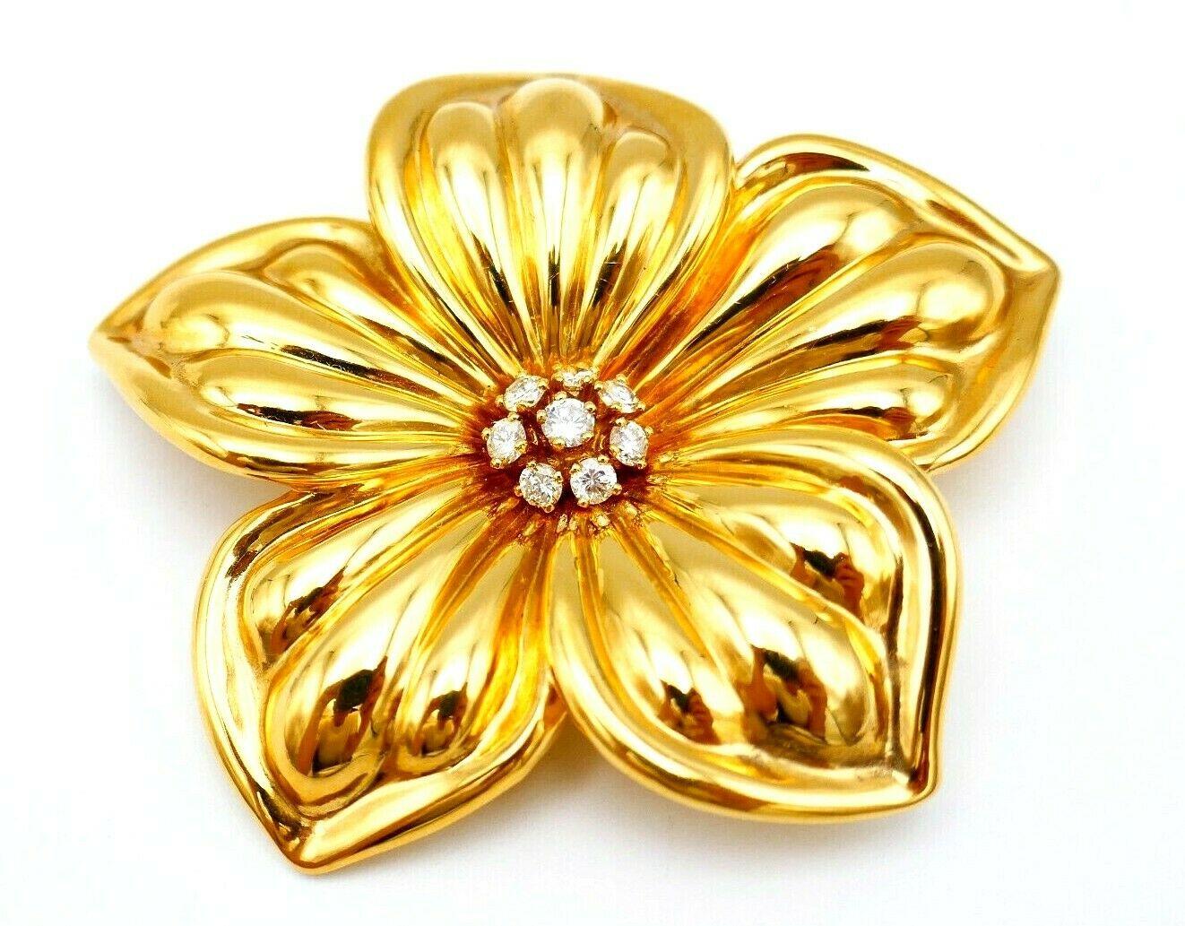 A gorgeous vintage Van Cleef & Arpels 18k yellow gold large Magnolia flower brooch. Features eight round brilliant cut diamonds, carat weight is  ~0.50 points. Stamped with VCA maker's mark, a country of origin (France) and a hallmark for 18k