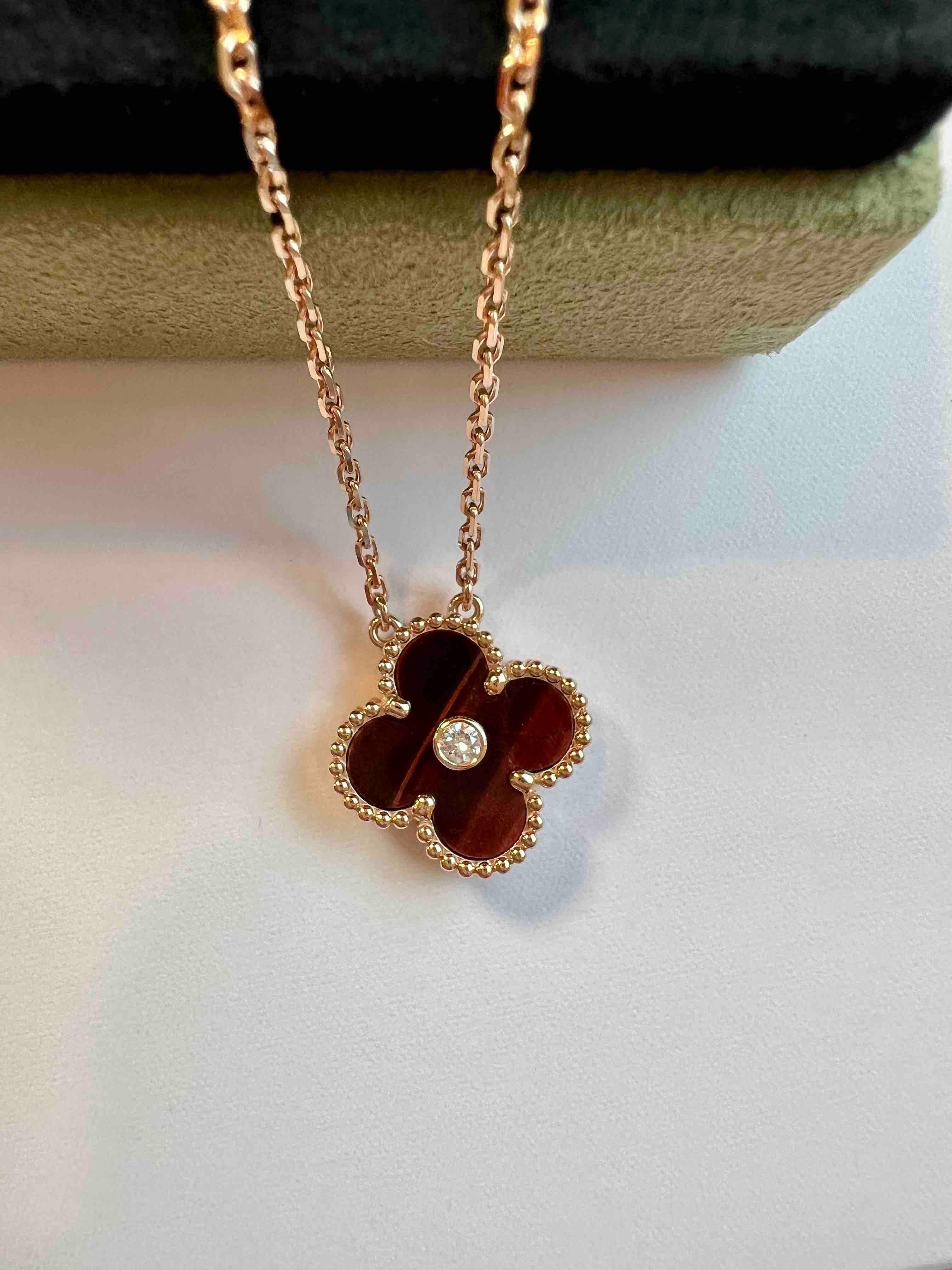 Van Cleef & Arpels 2017 Holiday Pendant of Vintage Alhambra, diamond, tiger eye necklace. Discontinued hard to get on the market. 

Maker: Van Cleef & Arpels

Accessories: Boxes, the original certificate dated 2017, and the necklace.

Condition:
