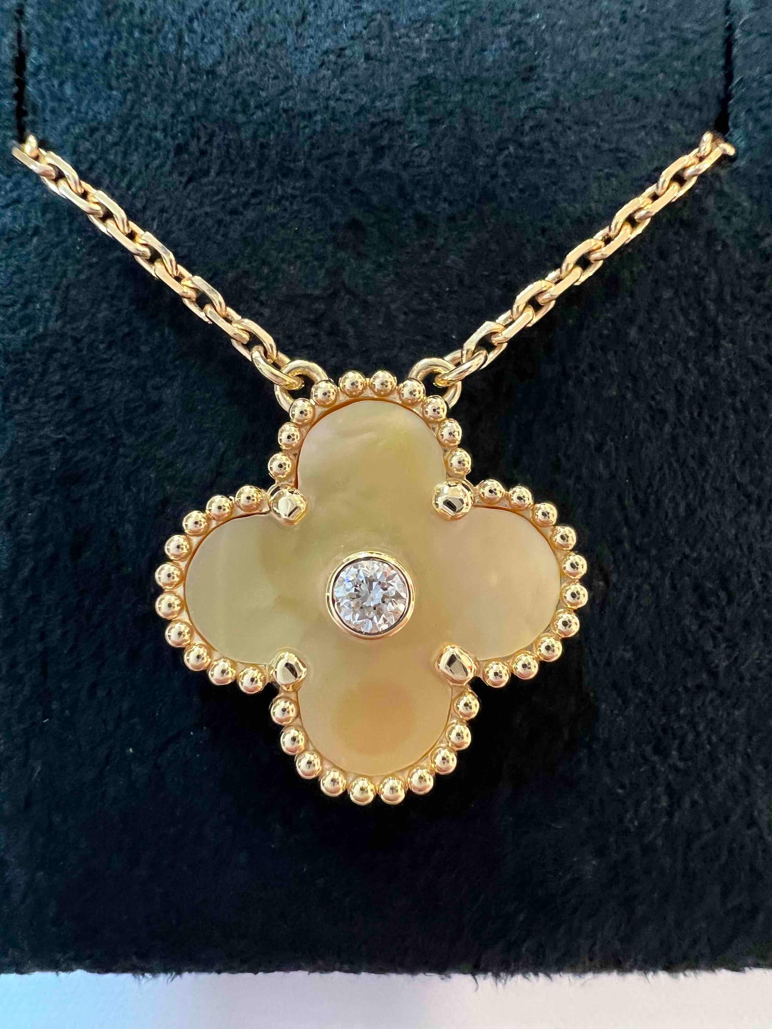 Van Cleef & Arpels 2018 Holiday Pendant of Vintage Alhambra, diamond, gold mother of pearl necklace. Discontinued hard to get on the market. 

Maker: Van Cleef & Arpels

Accessories: Boxes, the original certificate dated 2018, and the