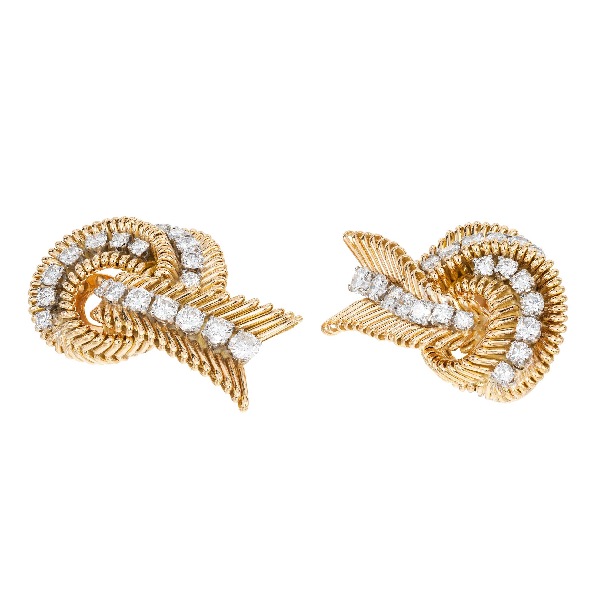 Classic 1960's diamond swirl Van Cleef & Arpels clip post earrings. These spectacular earrings are adorned with 40 round brilliant cut diamonds with a total weight of 2.30cts. A wire styling, twisted into swirl type design. The backs are clip posts.