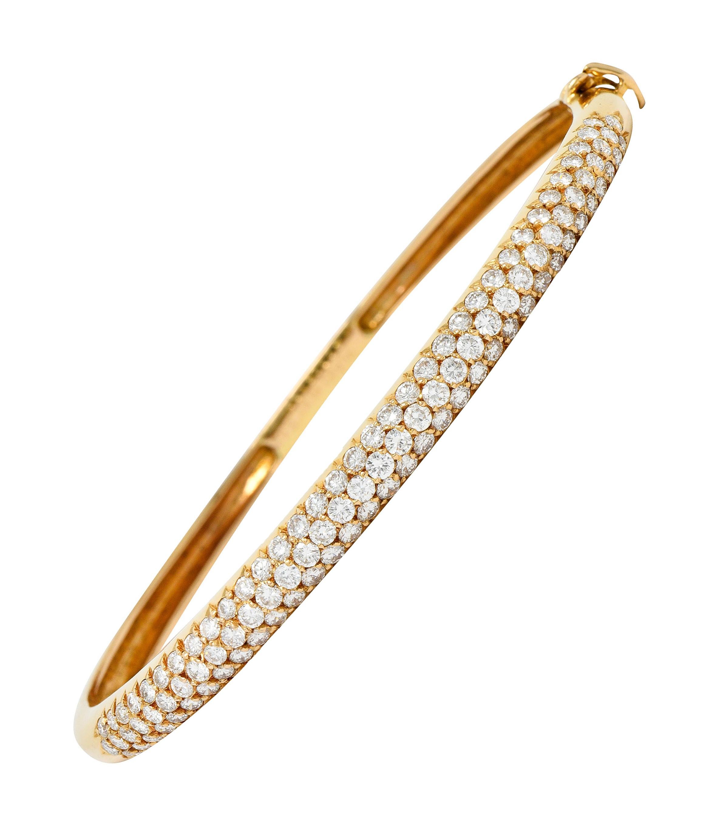 Hinged bangle bracelet is pavé set to front by round brilliant cut diamonds

Weighing in total 2.42 carats with F/G color and VS clarity

Completed by a concealed clasp with a fold-over safety

Stamped 18KT and with French assay mark for 18 karat