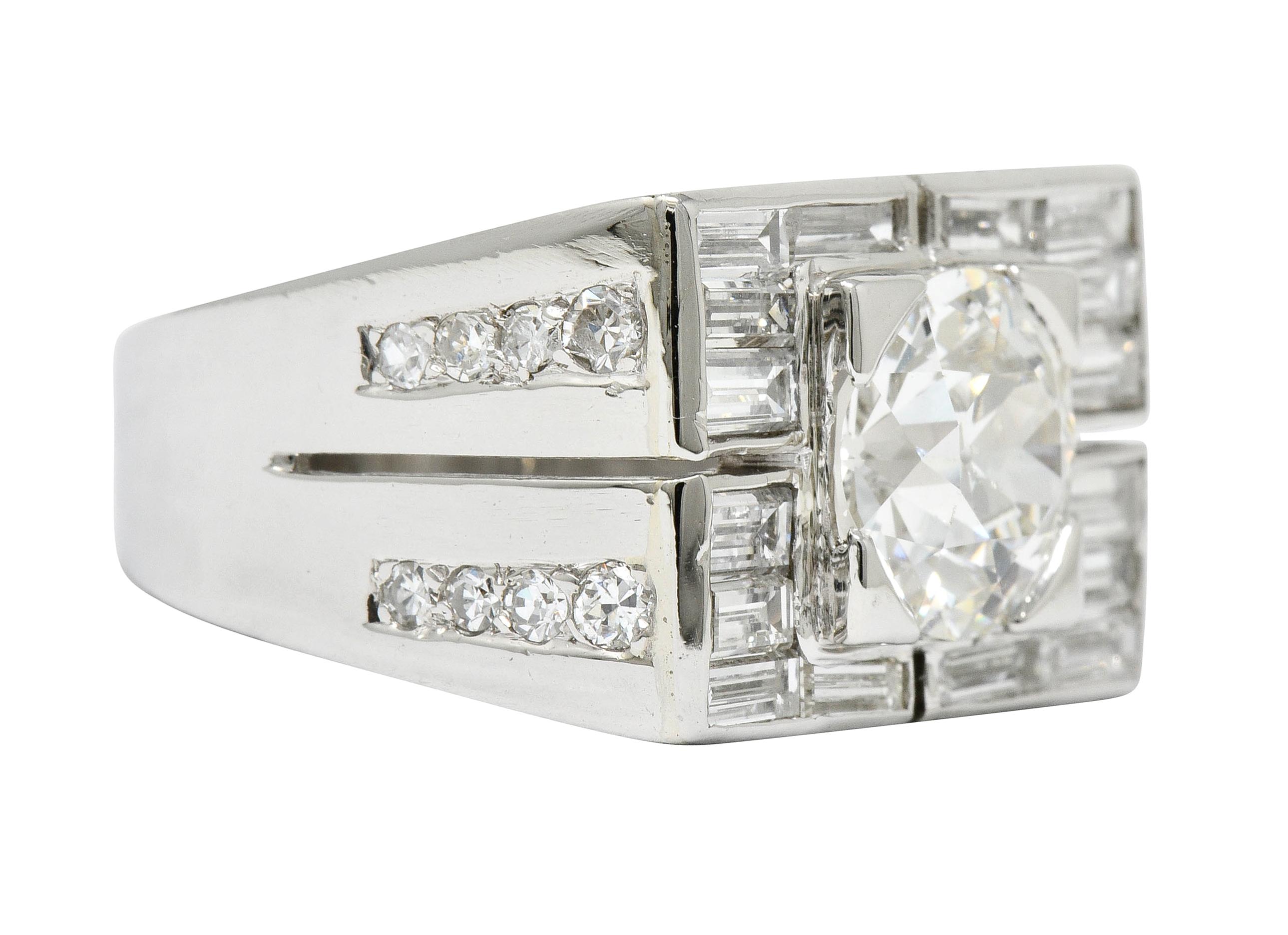 Centering a transitional cut diamond weighing approximately 2.34 carats, J color with VS1 clarity

Set in a low square form head in a rectangular mounting channel set with baguette cut diamonds weighing approximately 1.45 carats total; G/H color