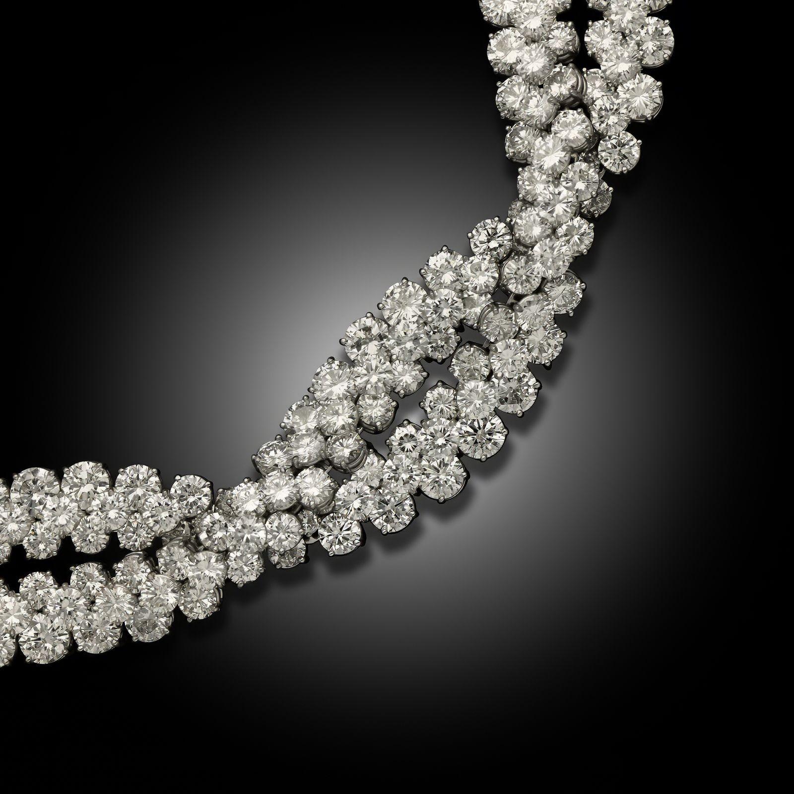 A vintage diamond and platinum 'Natte' (braid) bracelet , by Van Cleef & Arpels, circa 1960. The highly flexible bracelet is designed as two entwined 'ribbons' with 50cts of round brilliant cut diamonds set in platinum and secured by a concealed