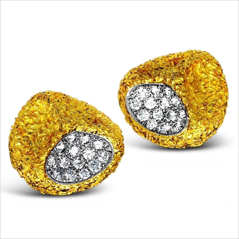 A pair of abstract gold and diamond ear clips by Van Cleef & Arpels c.1965, each of rounded triangular design with three 'thumb print' indents and formed of heavily textured 18ct yellow gold, one indent in each earring is pavé set with round