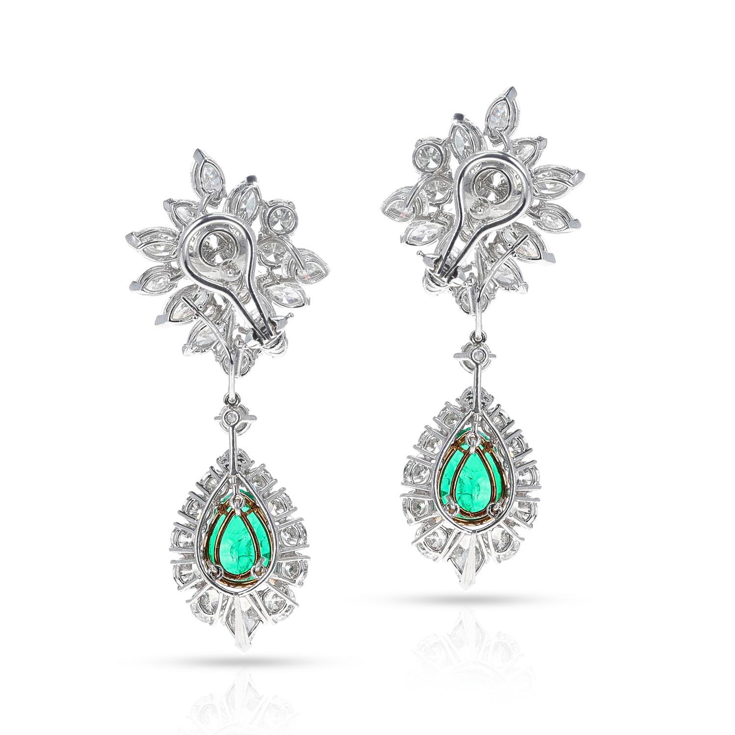 A pair of Van Cleef & Arpels AGL Certified Colombian Emerald and Diamond Day and Night Earrings made in Platinum. The pear-shaped mixed-cut emeralds weigh appx. 2.75 cts and 3.30 cts. The diamonds, round brilliant-cut, pear-shape, and marquise-cut