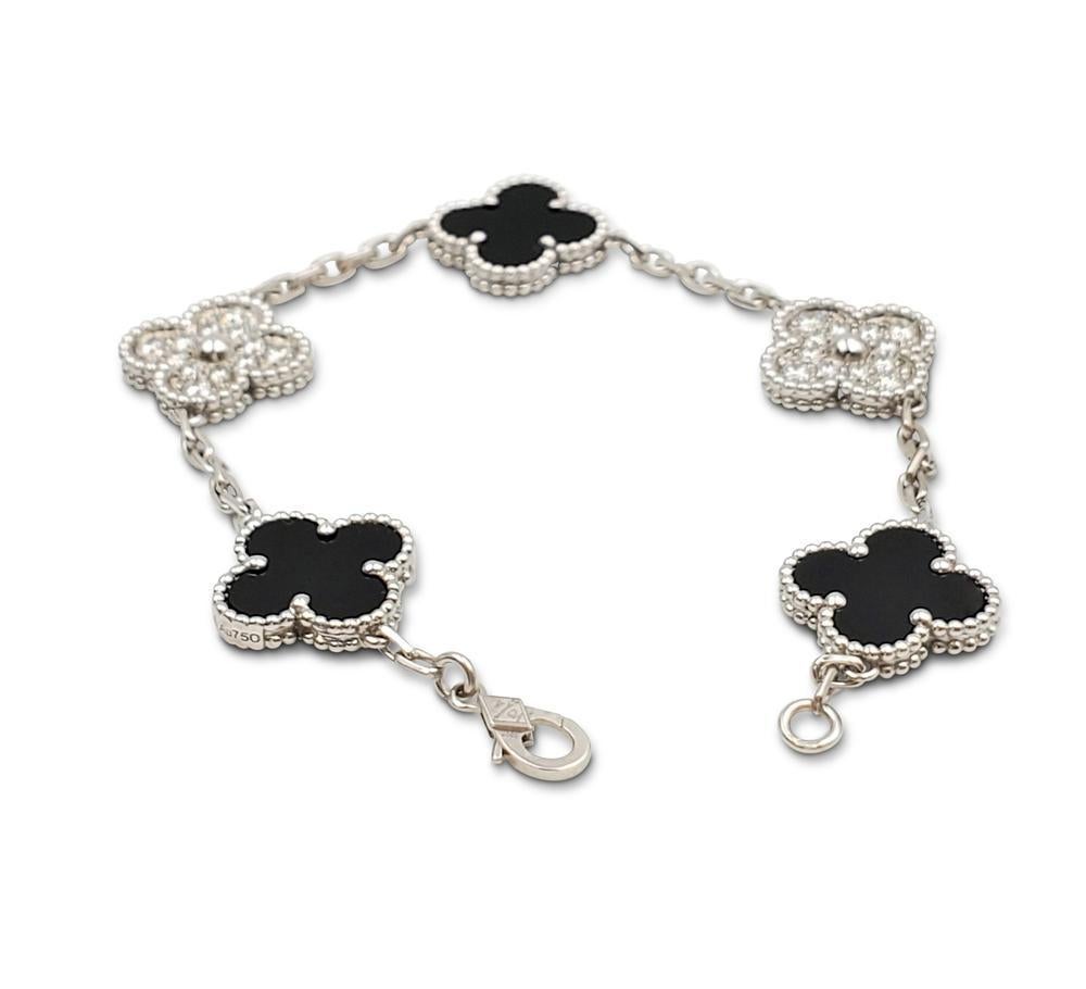 Authentic Van Cleef & Arpels Alhambra bracelet crafted in 18 karat white gold features alternating clover motifs of onyx and pave diamonds (D-E-F color, IF to VVS clarity) weighing an estimated 0.97 carat total weight. The bracelet measures 7.09