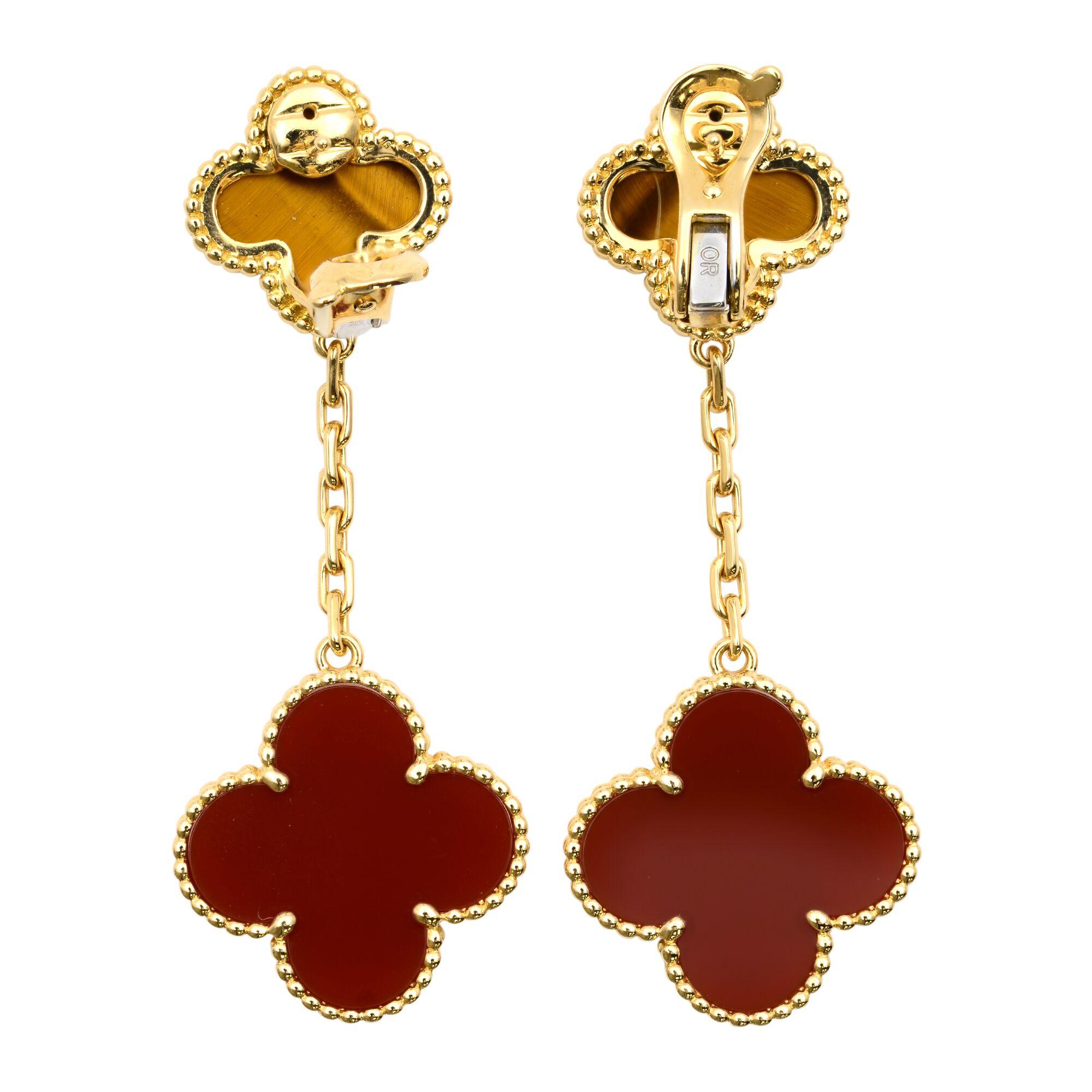 Van Cleef & Alhambra Magic Alhambra earrings, 2 motifs, 18K yellow gold, tiger’s eye, carnelian. Length: 2 inches.
Condition: pre-owned like new, comes with box and papers.