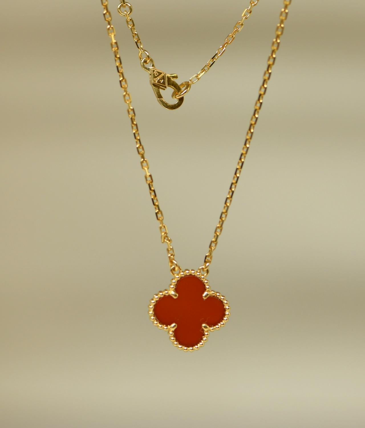 A classic Van Cleef & Arpels Alhambra carnelian pendant necklace. 

This is the kind of piece that will become a staple of your jewellery collection. You will find yourself reaching for it time after time. It will go with almost any outfit and add a