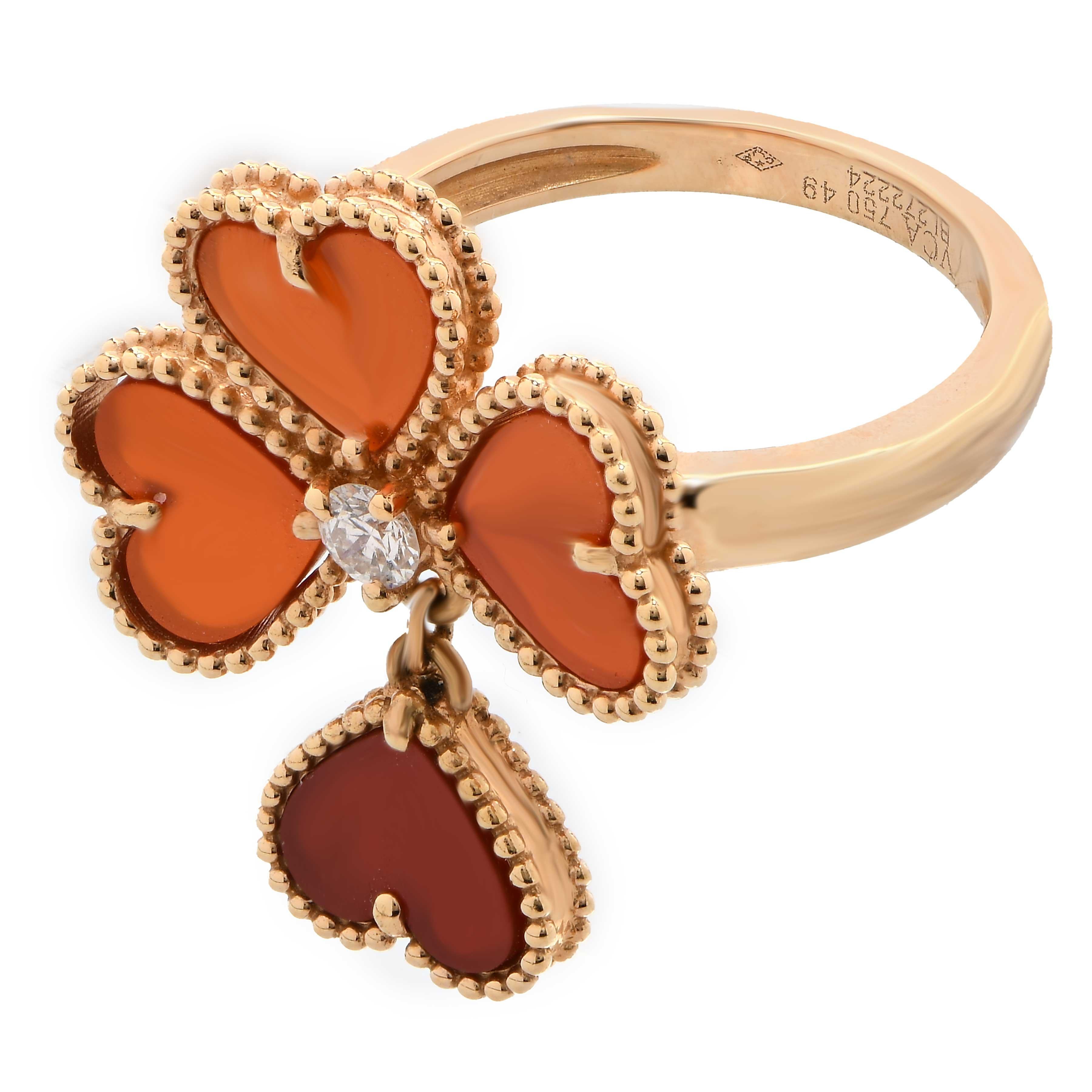 The Van Cleef & Arpels Alhambra Cornelian and Diamond 18 Karat Yellow Gold Ring is an exquisite piece of jewelry that exemplifies the brand's iconic design and craftsmanship. Here are its key features:

Design: The ring is part of the Alhambra