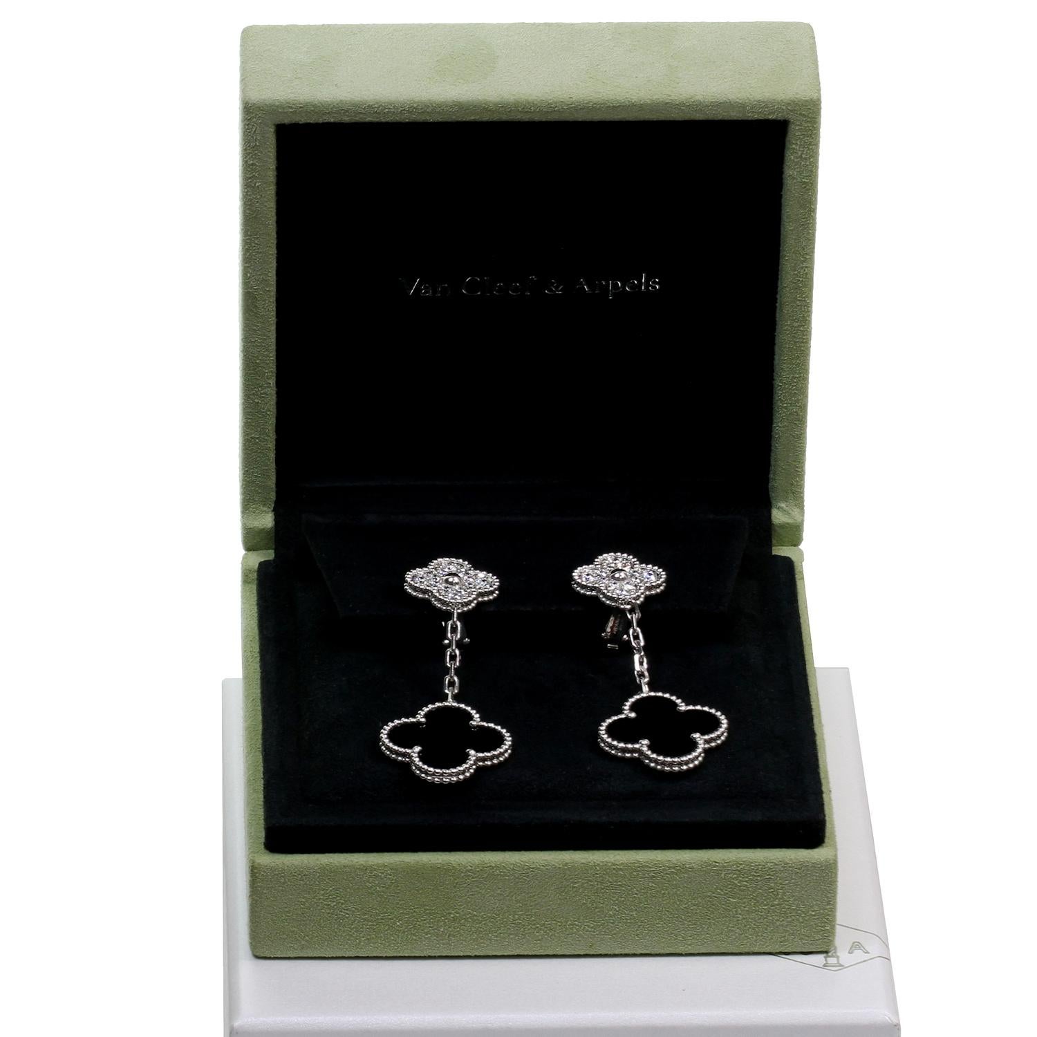 These fabulous dangling Van Cleef & Arpels earrings from the classic Alhambra collection each features 2 lucky clover motifs crafted in 18k white gold and set with black onyx and with round brilliant D-E-F VVS1-VVS2 diamonds weighing an estimated