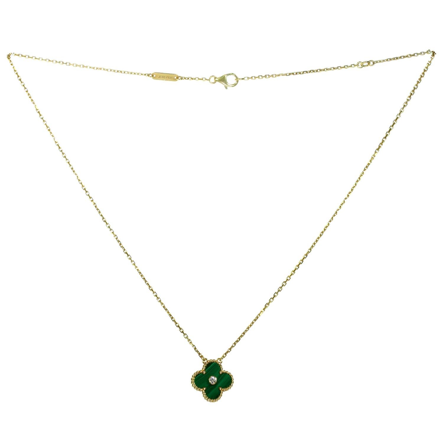 This rare and classic limited edition necklace from the iconic Alhambra collection by Van Cleef & Arpels features a lucky clover pendant crafted in 18k yellow gold and green malachite and bezel-set with a round brilliant D-E-F VVS1-VVS2 diamond