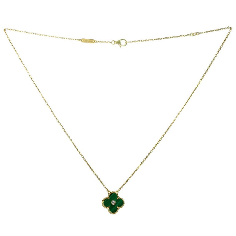 This rare and classic limited edition necklace from the iconic Alhambra collection by Van Cleef & Arpels  features a lucky clover pendant crafted in 18k yellow gold and green malachite and bezel-set with a round brilliant D-E-F VVS1-VVS2 diamond