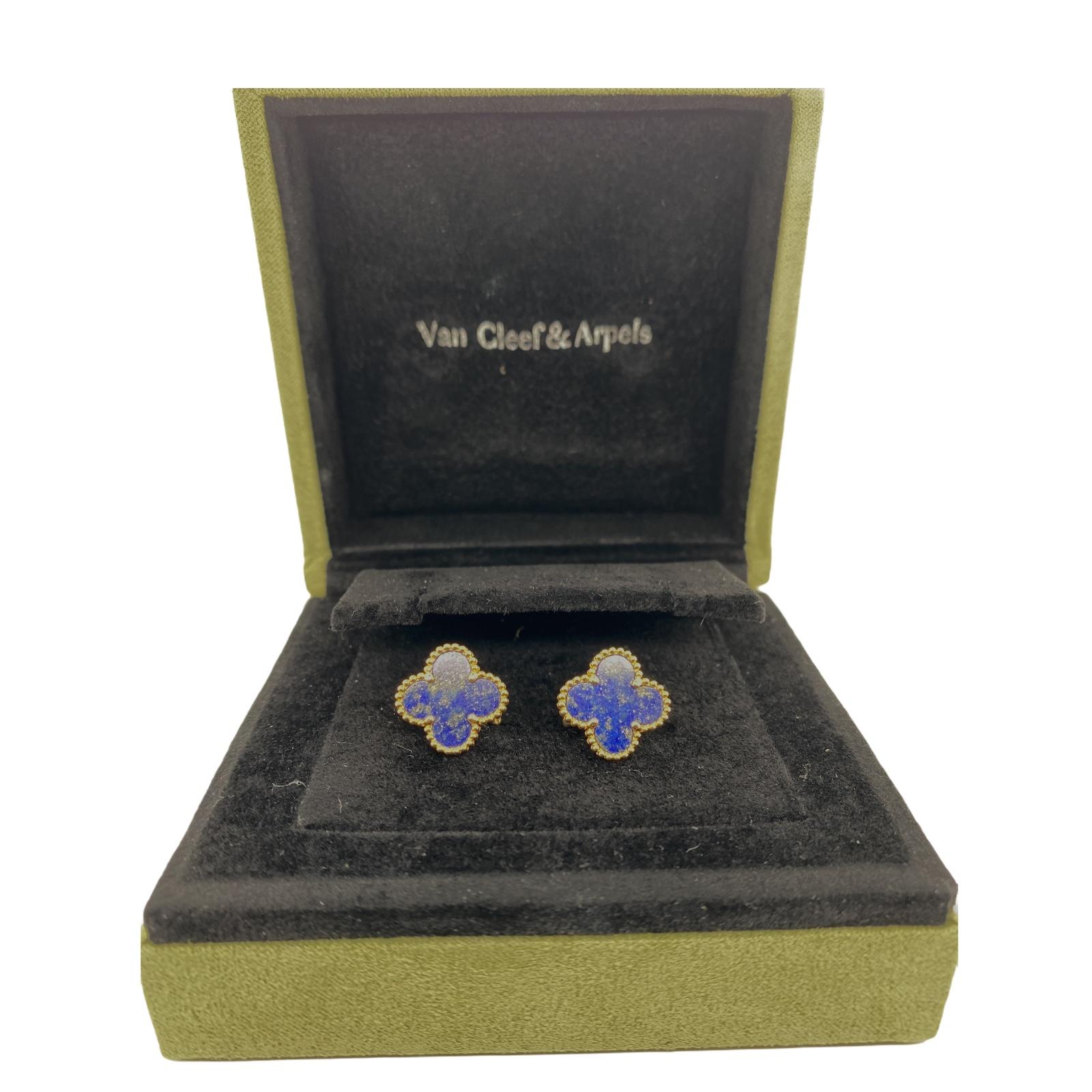 Van Cleef & Arpels lapis lazuli Alhambra earrings fashioned in 18 karat yellow gold. The earrings feature two lapis lazuli gemstones set in a clover motif. The Alhambra earrings with lapis are no longer available. The earrings measure 14.75 x