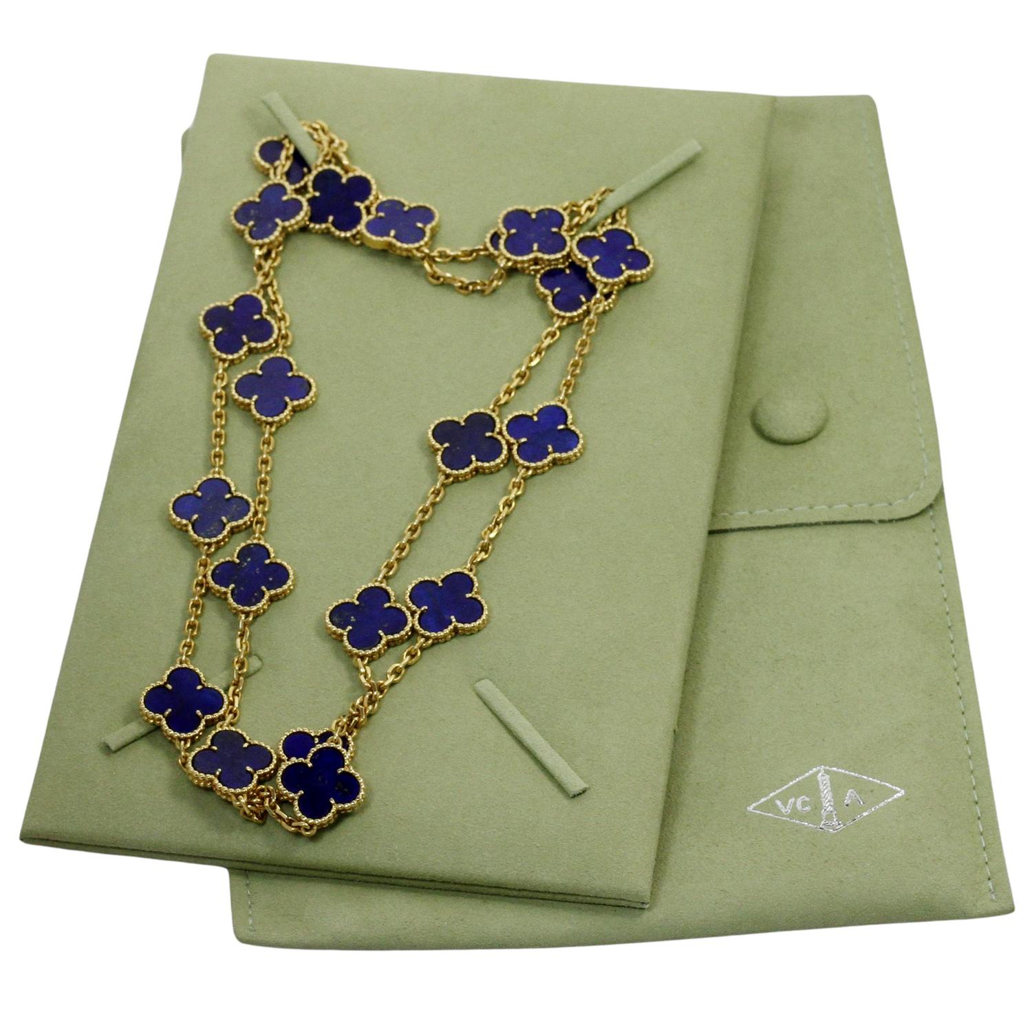 This gorgeous rare Van Cleef & Arpels 20-motif lucky clover necklace from the iconic Alhambra collection is crafted in 18k yellow gold and inlaid with blue lapis lazuli in round bead settings. Made in France circa 1980s. Measurements: 0.59