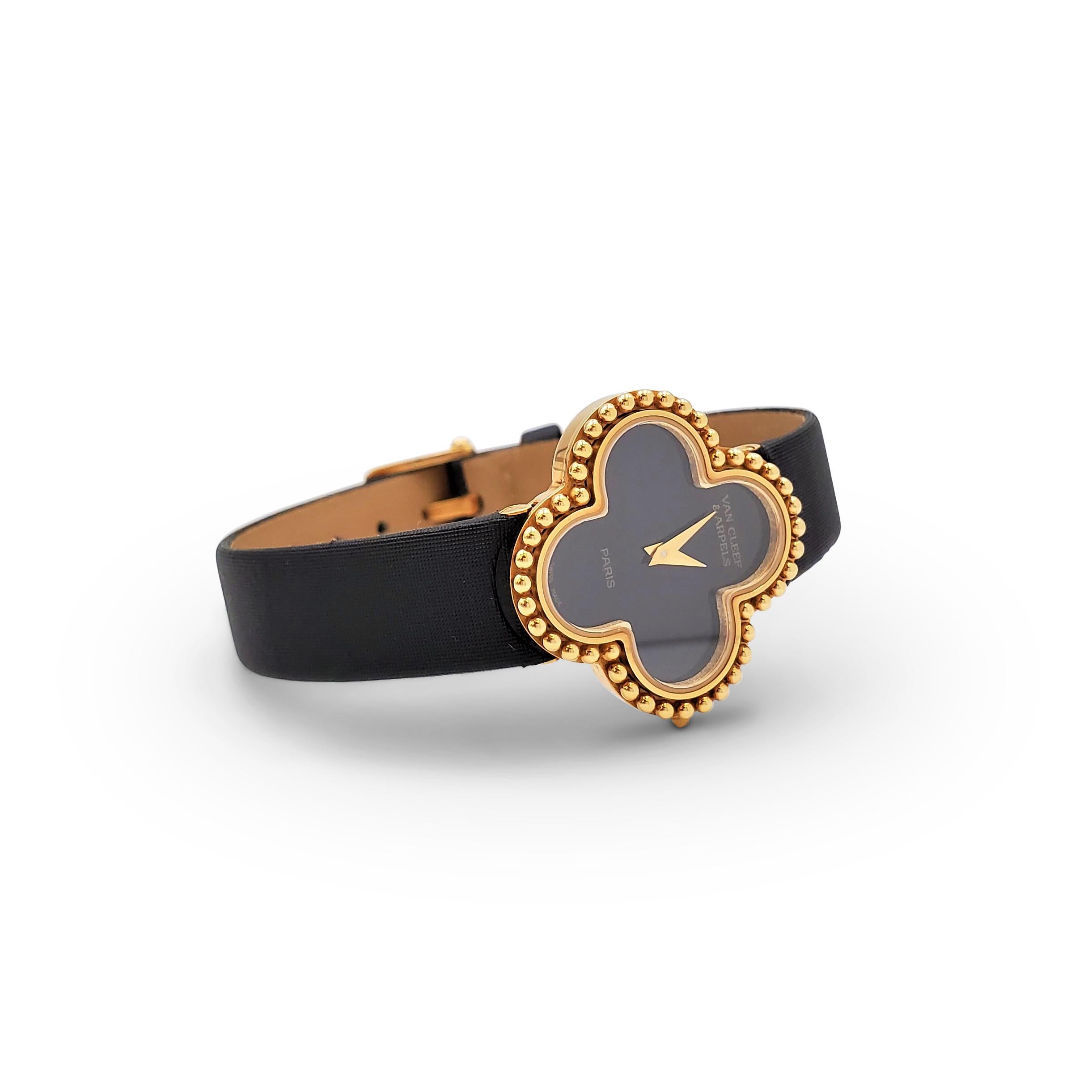 Authentic Van Cleef & Arpels 'Alhambra' watch. Centering on the classic clover motif, the watch bezel and case (26mm x 26mm) are crafted in 18 karat yellow gold. A chic black onyx dial features gold-toned sword-shaped hands and signed Van Cleef &