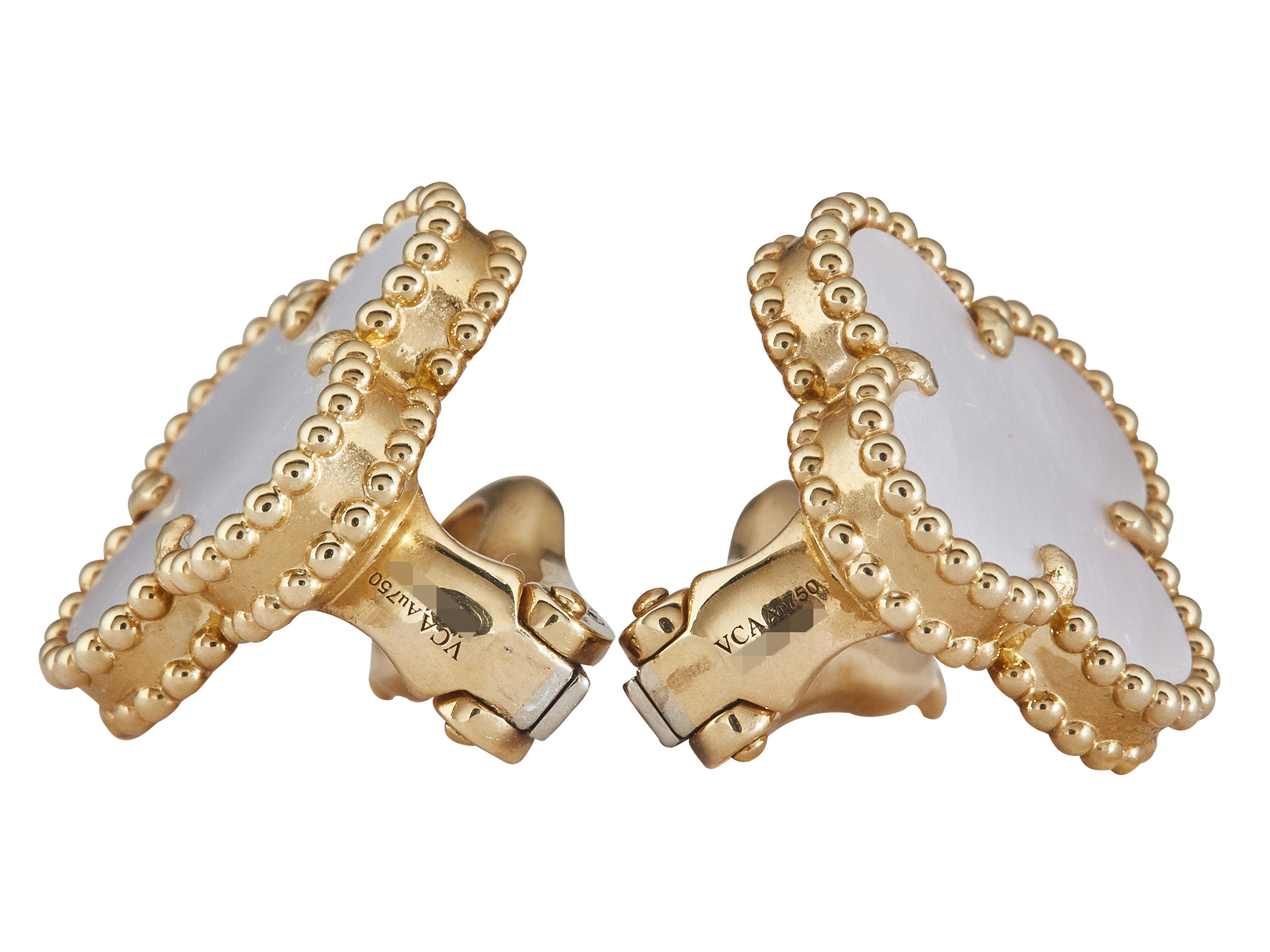 The earrings: A pair of Van Cleef & Arpels Alhambra Vintage ear clips. Each designed as a single mother-of-pearl earring set in beaded eighteen karat yellow gold. They are fitted with removeable posts and clip backs.

The earrings are in excellent