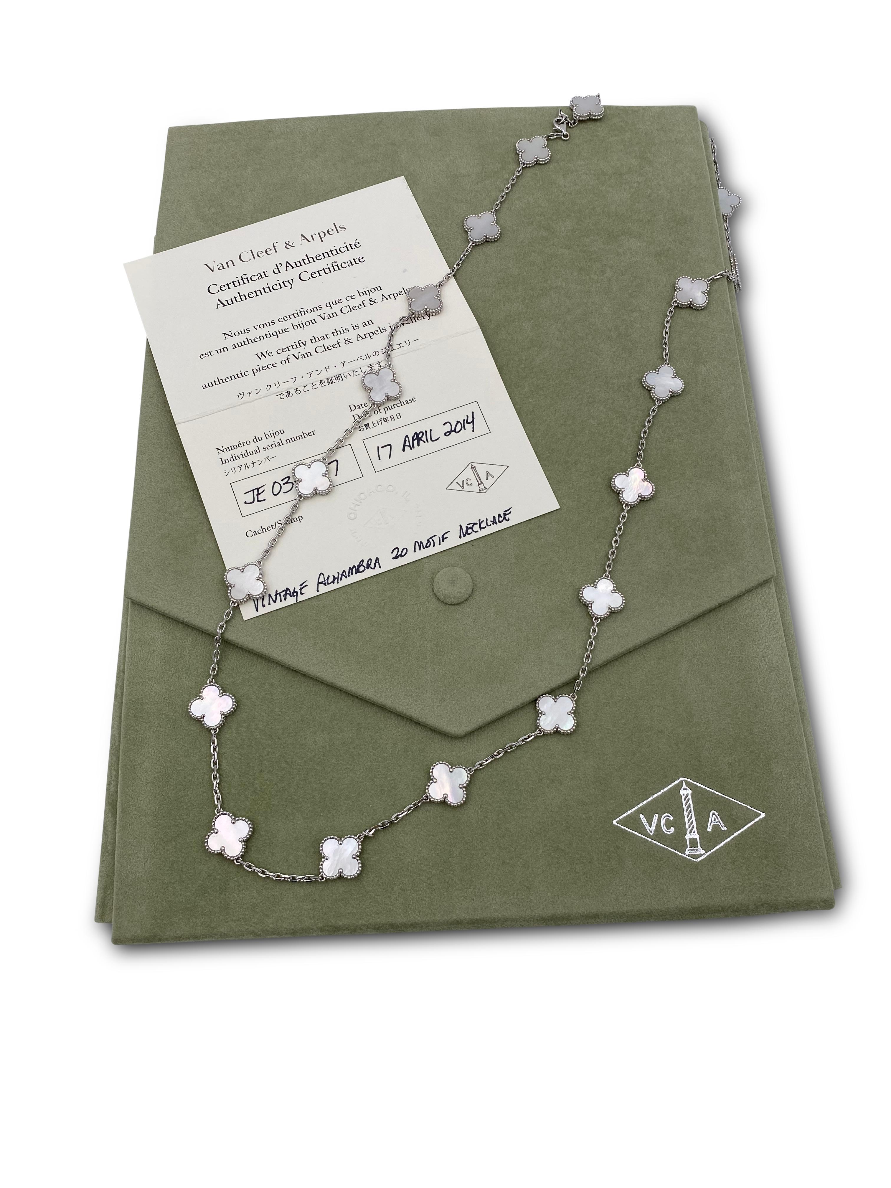 Authentic Van Cleef & Arpels 18 karat white gold long necklace featuring 20 clover leaf inspired motifs set with carved mother-of-pearl stones. The necklace is presented with original Van Cleef & Arpels box and papers. Measures 32 1/2 inches in