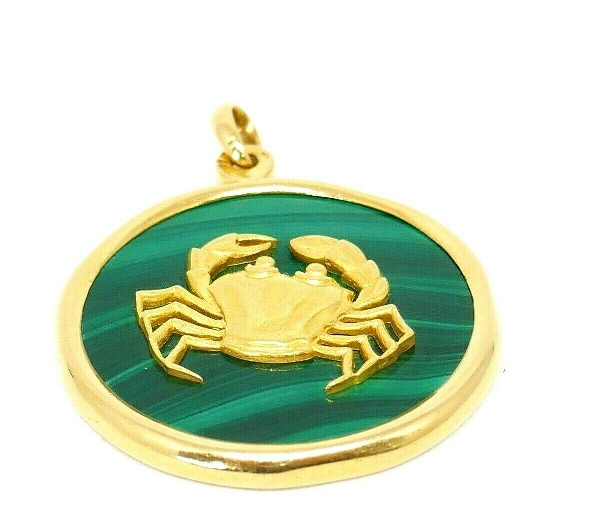 Bright, eye-catching pendant by Van Cleef & Arpels, made is France in the 1970s. 
The collection was inspired by Astrological Zodiac motifs. This one features a gold cancer sitting on a malachite disc. These pendants are difficult to find as its
