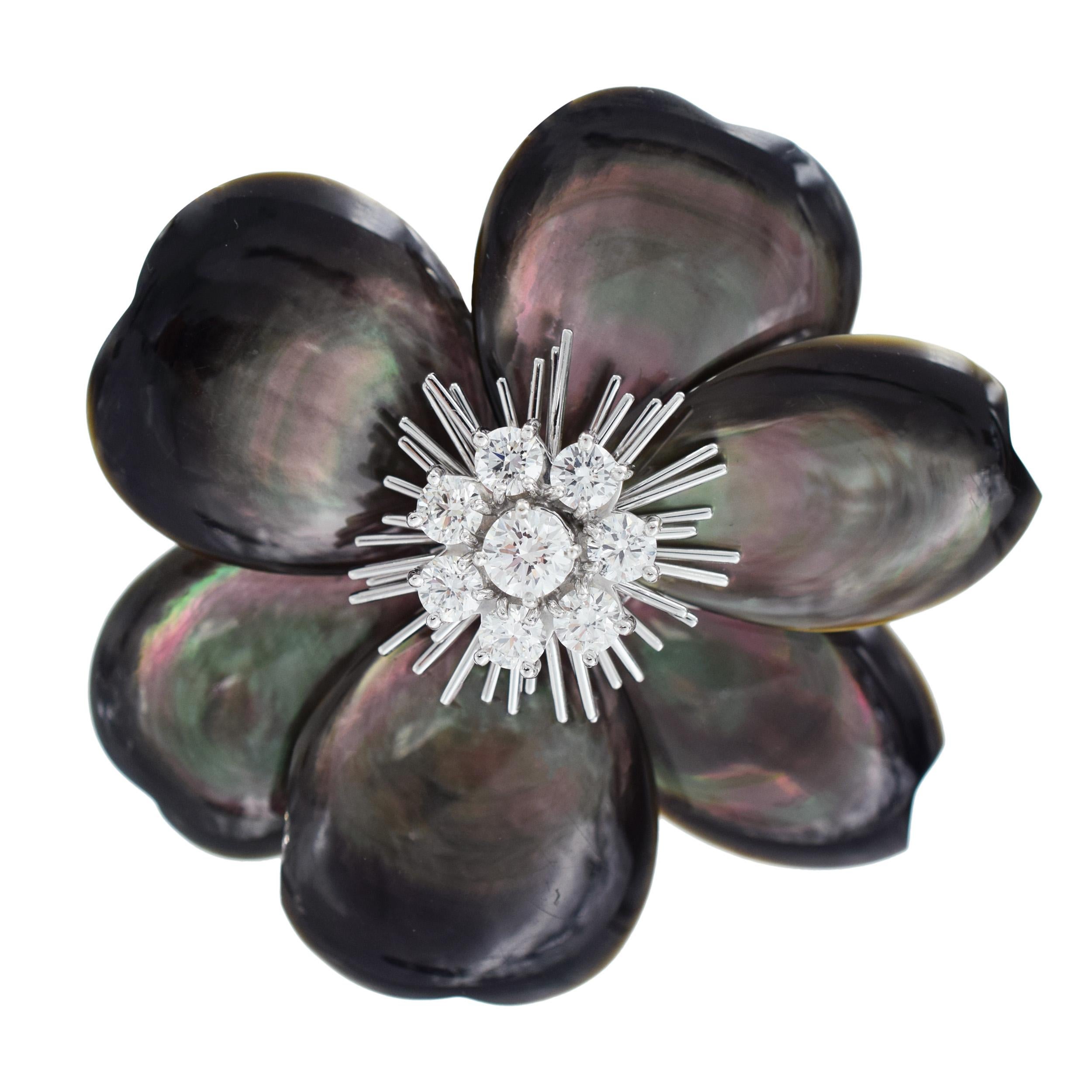 Black Mother-Of-Pearl ‘Rose de Noel’ brooch by Van Cleef & Arpels. This brooch
is designed in floral motif, featuring six Mother of Pearl petals and center set with eight round brilliant cut diamonds with total weight of 1.54 carats, color E,