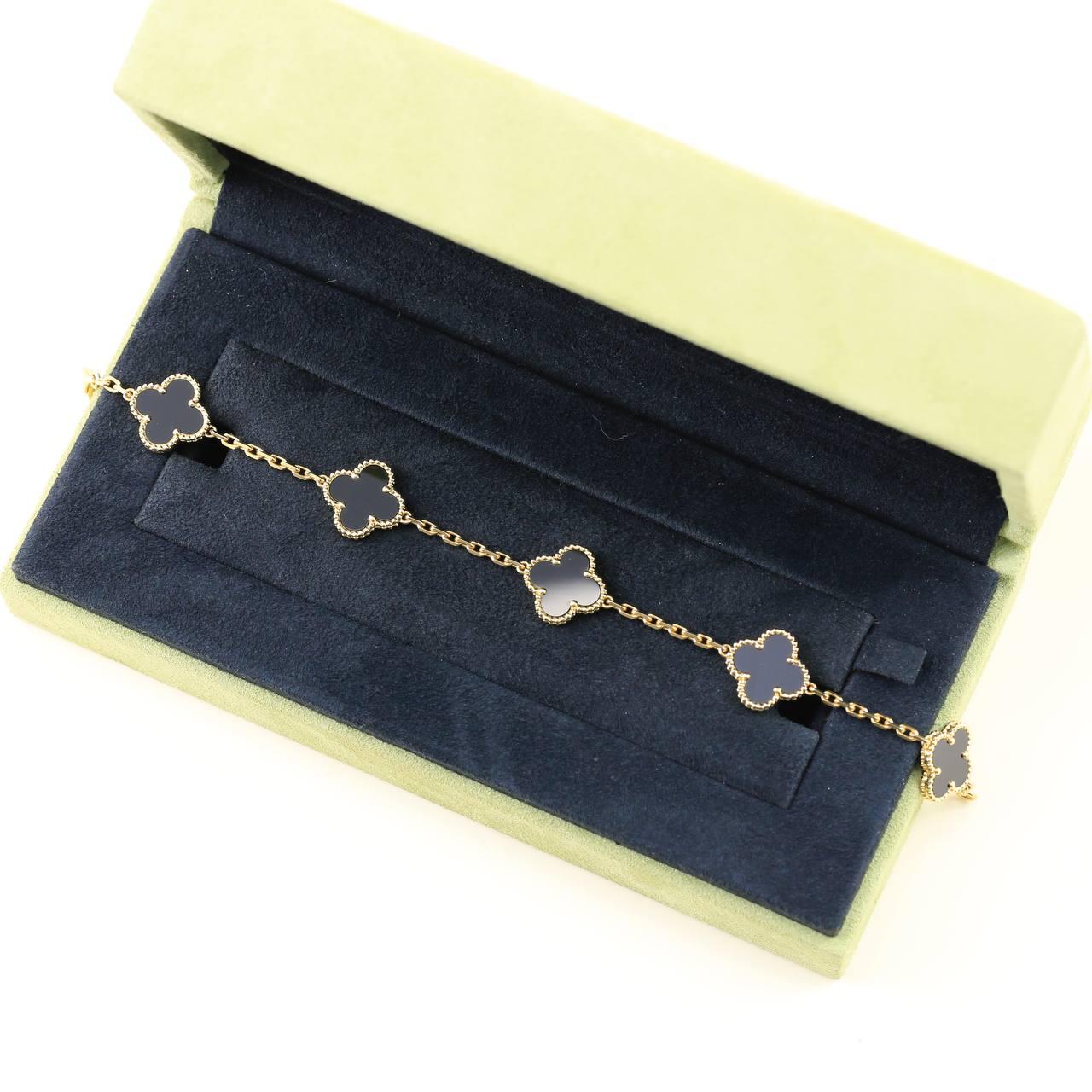 An 18k yellow gold bracelet from the Vintage Alhambra collection by Van Cleef and Arpels. The bracelet is made up of 5 iconic clover motifs, each set with a beaded edge and a black onyx inlay, set throughout the length of the chain.

SKU