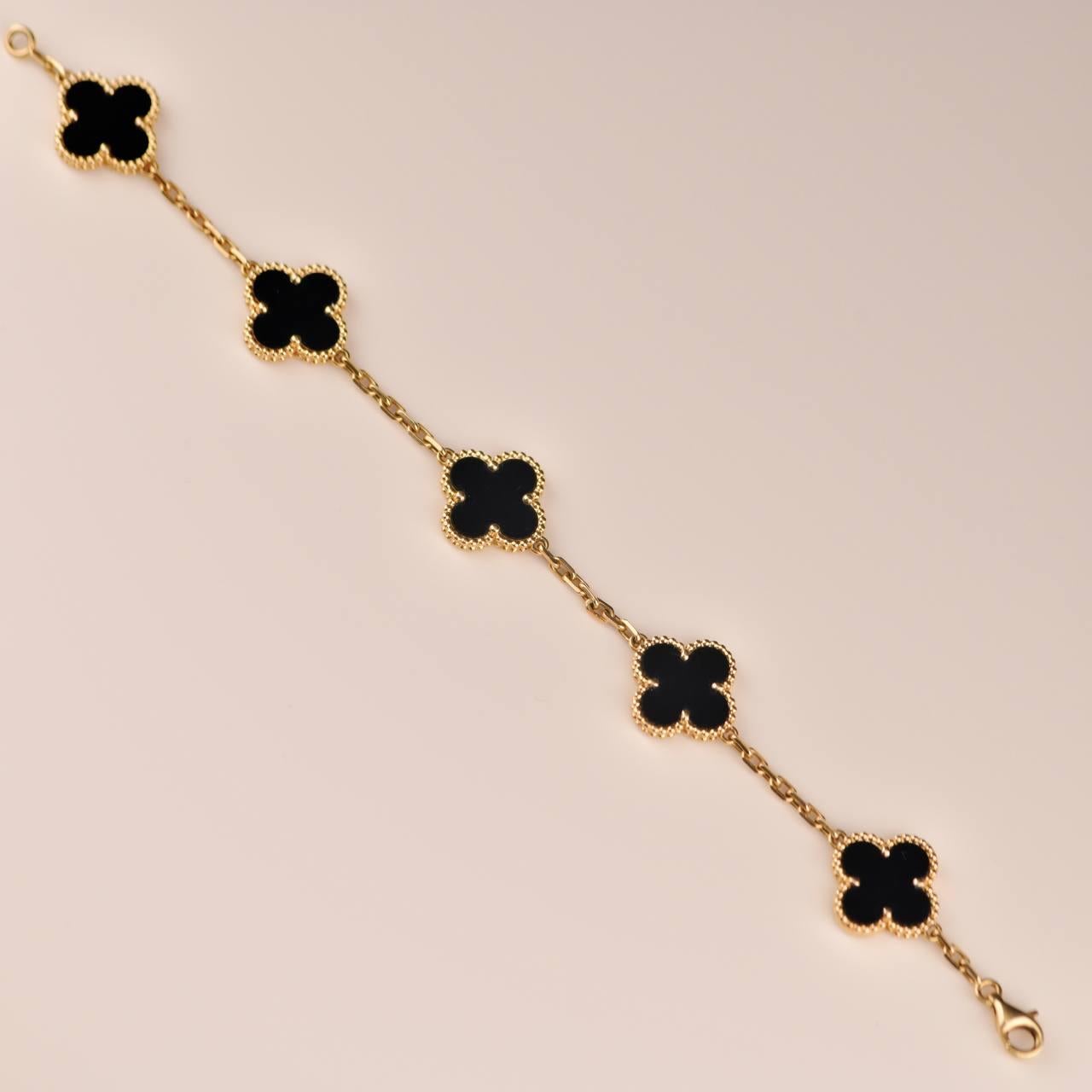 An 18k yellow gold bracelet from the Vintage Alhambra collection by Van Cleef and Arpels. The bracelet is made up of 5 iconic clover motifs, each set with a beaded edge and a black onyx inlay, set throughout the length of the chain.

SKU