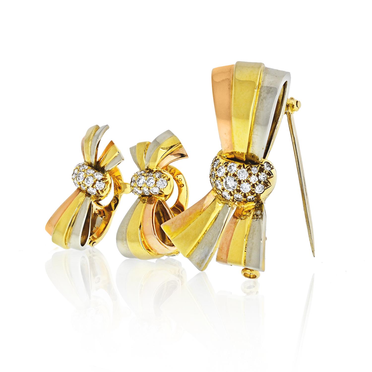 Gold set of bow earrings and a brooch, in 18k tri color gold, by Van Cleef & Arpels, adorned with approx. 0.55ctw in diamonds total. Earrings measure 23mm x 12mm, brooch - 35mm x 24mm. Marked: VCA, 750, or, 83, French marks. Weight - 22.5