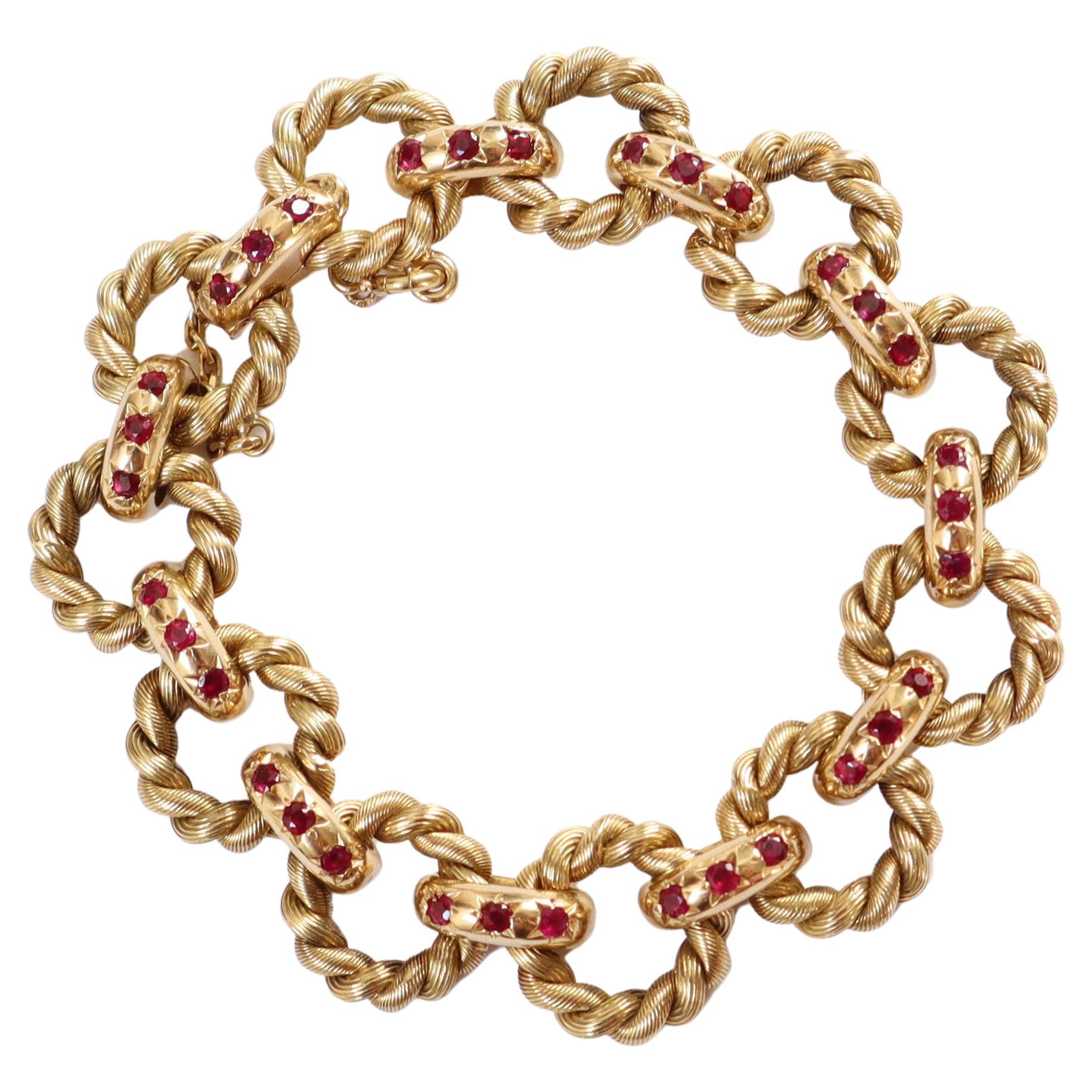 Van Cleef & Arpels Bracelet in 18K Yellow Gold and Rubies with Twisted Hoops For Sale