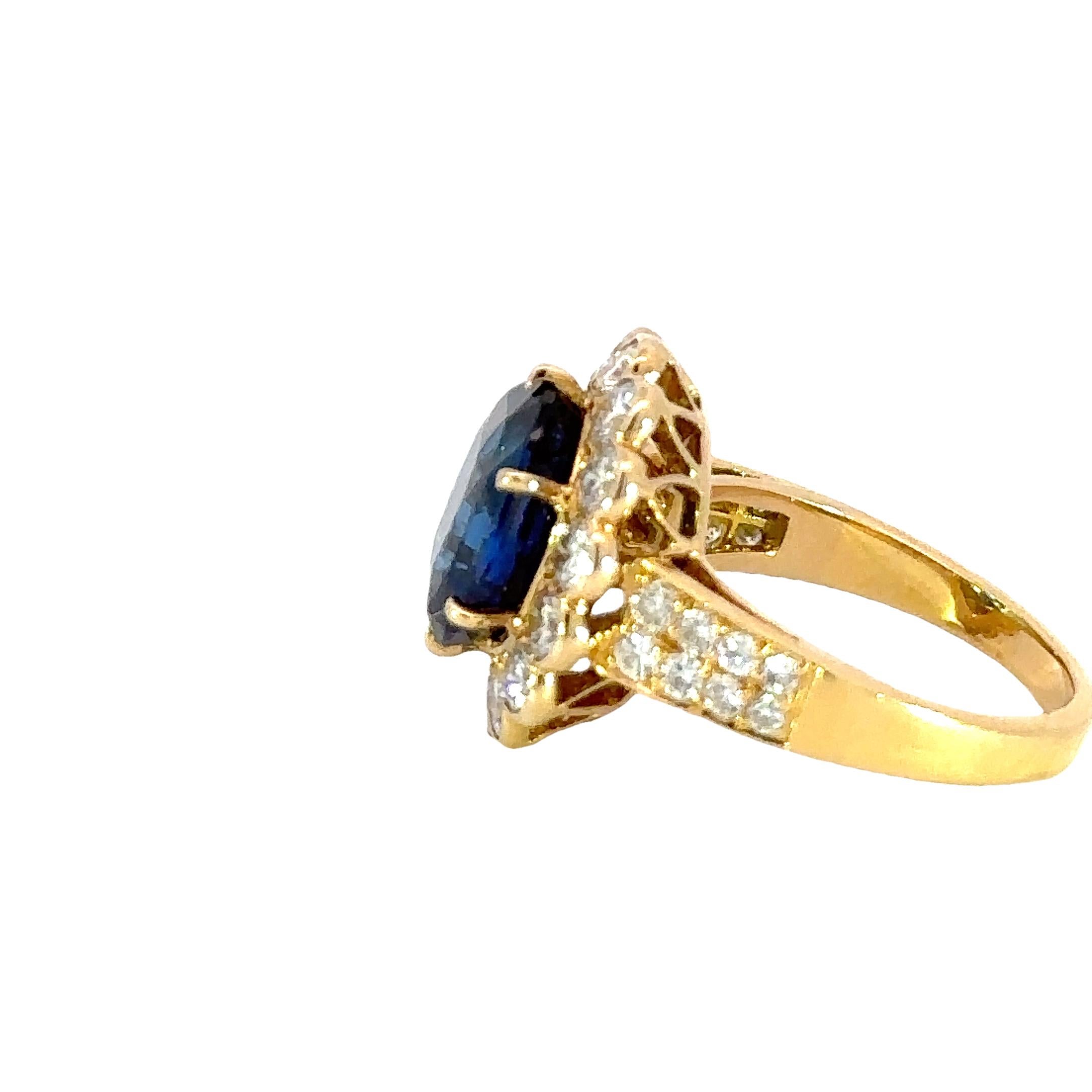 A symphony of elegance and brilliance.

This stunning ring showcases a magnificent 6.23 carat oval-cut sapphire, radiating a deep blue hue. Encircling the central gem is a halo of sparkling diamonds, enhancing its vibrant color. The intricate design