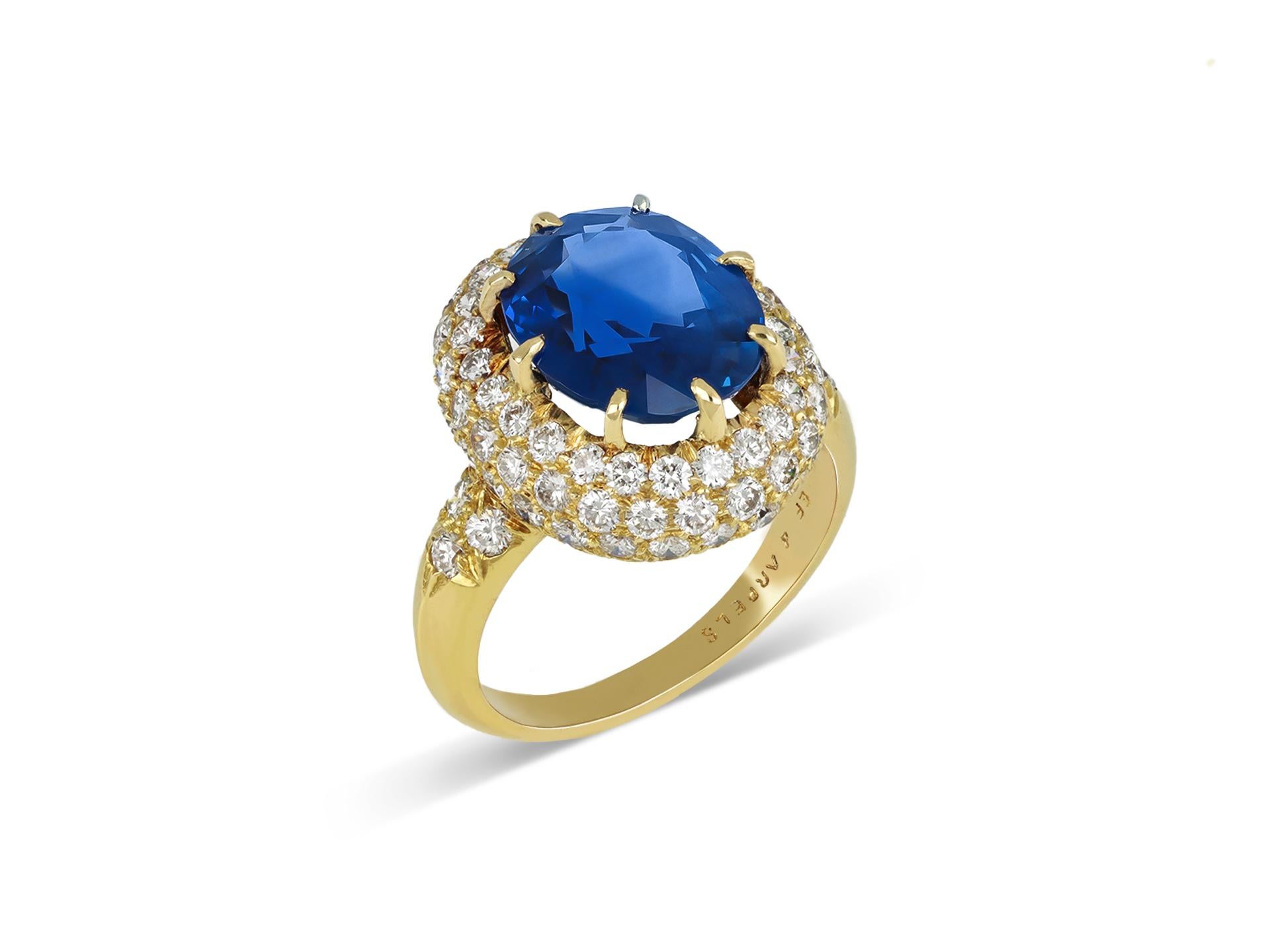Van Cleef & Arpels Burmese sapphire and diamond cluster ring. Set with a natural unenhanced oval old cut Burmese sapphire to centre in an open back claw setting with an approximate weight of 5.56 carats, encircled by three rows of round brilliant