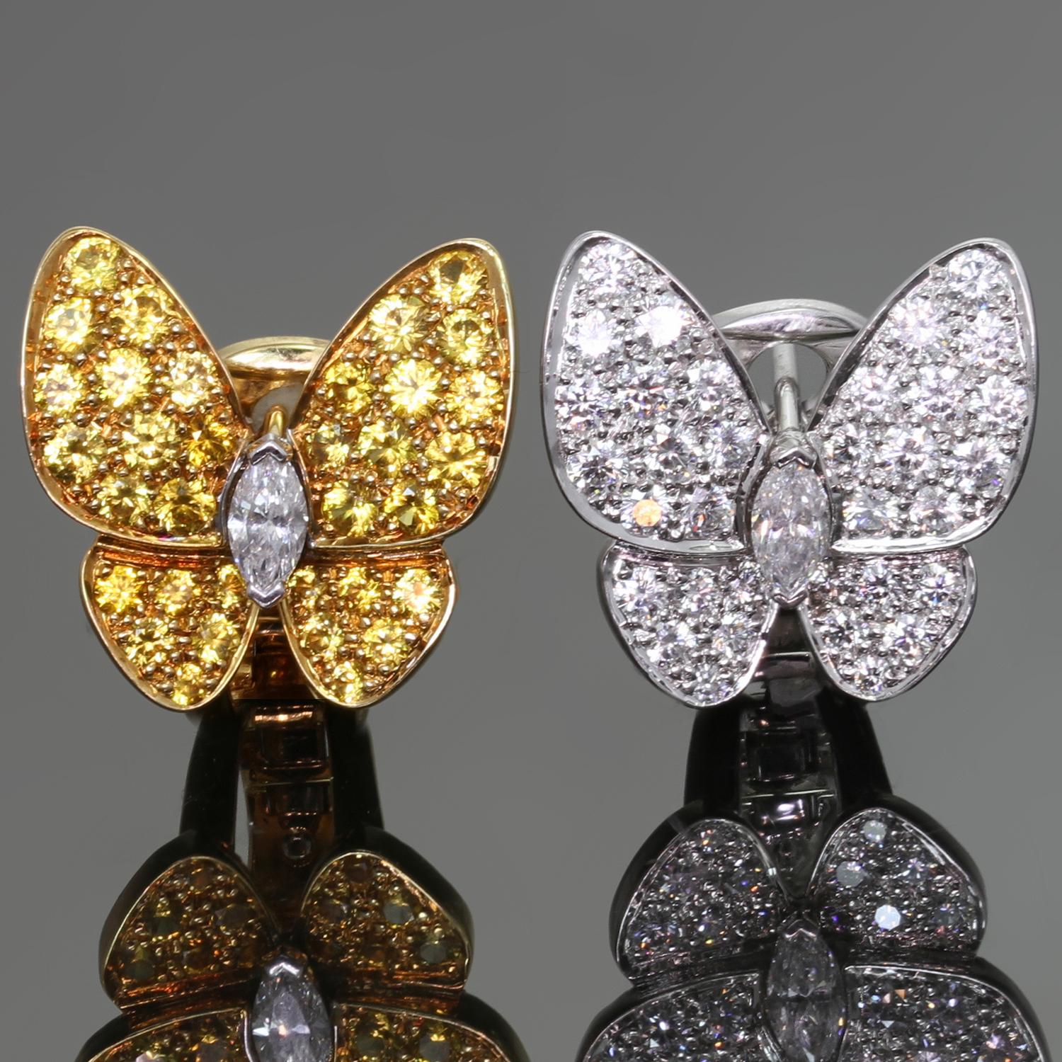 These exquisite Van Cleef & Arpels earrings feature a classic butterfly design with one earring crafted in 18k yellow gold and set with yellow sapphire gemstones weighing an estimated 0.88 carats and another earring crafted in 18k white gold and set