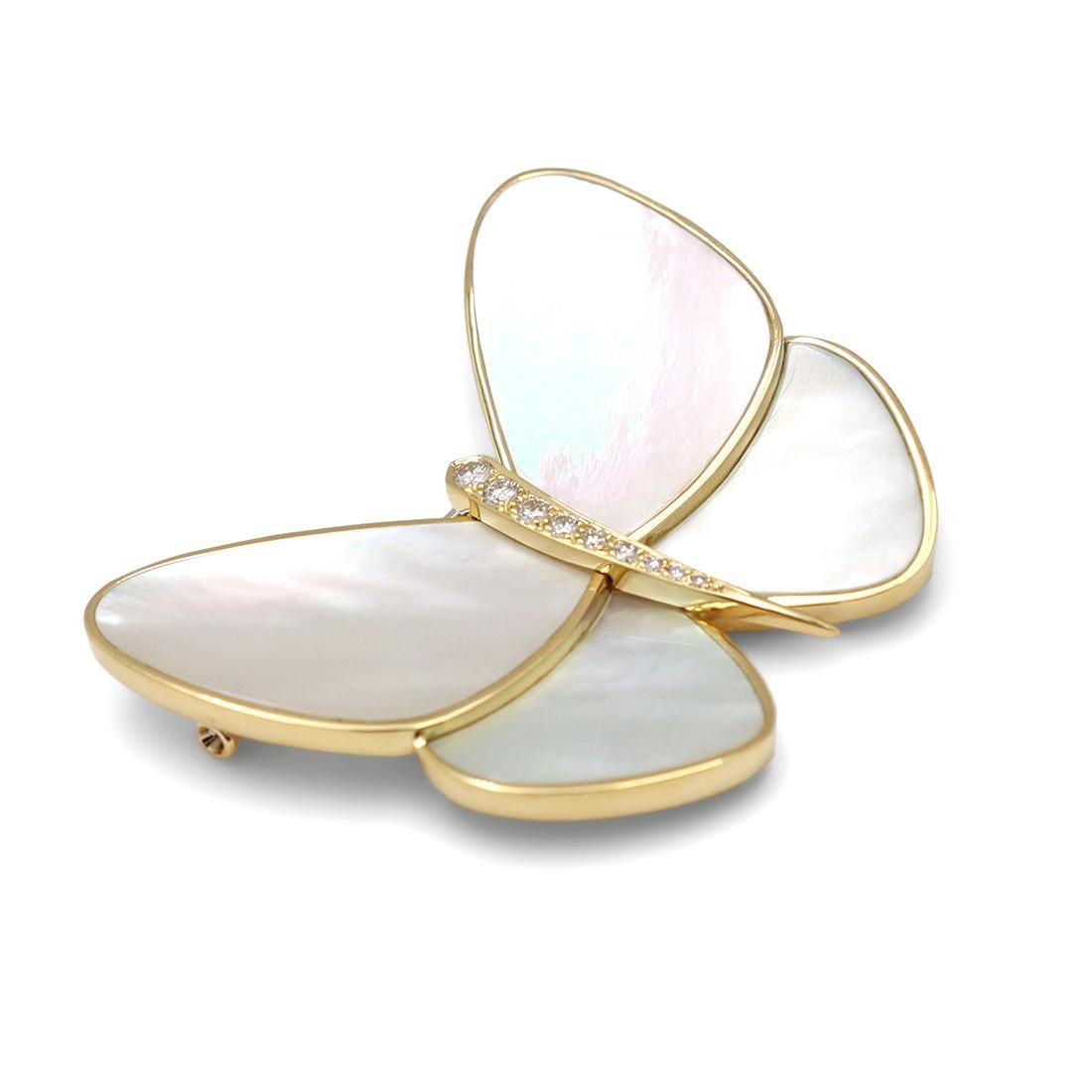 Authentic Van Cleef & Arpels pin crafted in 18 karat yellow gold.  The wings are comprised of carved white mother-or-pearl. The body of the butterfly is set with 9 round brilliant cut diamonds weighing an estimated 0.23 carat total weight (DEF