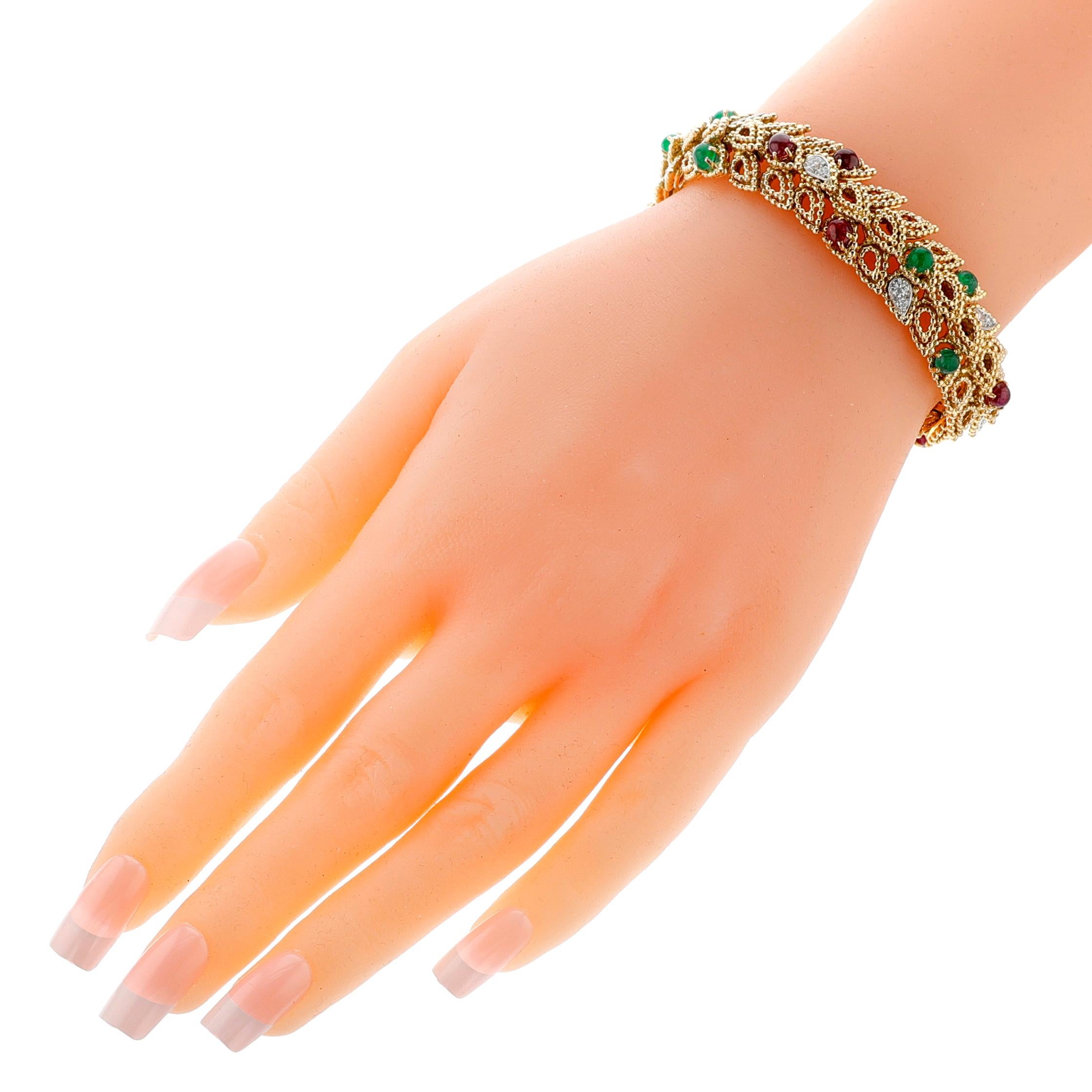 A 1960s Van Cleef & Arpels Gold-Work Emerald and Ruby Cabochon with Diamond Bracelet made in 18k Yellow Gold with Platinum. The bracelet has ruby cabochons, emerald cabochons, and round brilliant-cut diamonds. French hallmarks, maker’s mark of André