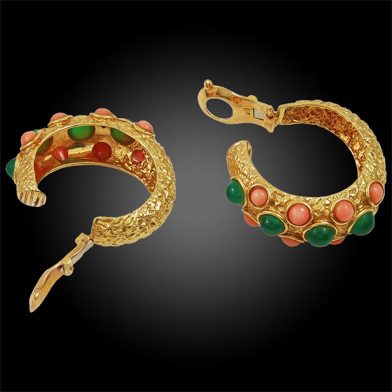 A lovely pair of hoop ear clips by Van Cleef & Arpels that dates back to the 1970s, set at the center with a series of vibrant cabochon chrysoprase orbs surrounded at each side with rows of stunning coral orbs, finely mounted in textured 18k yellow