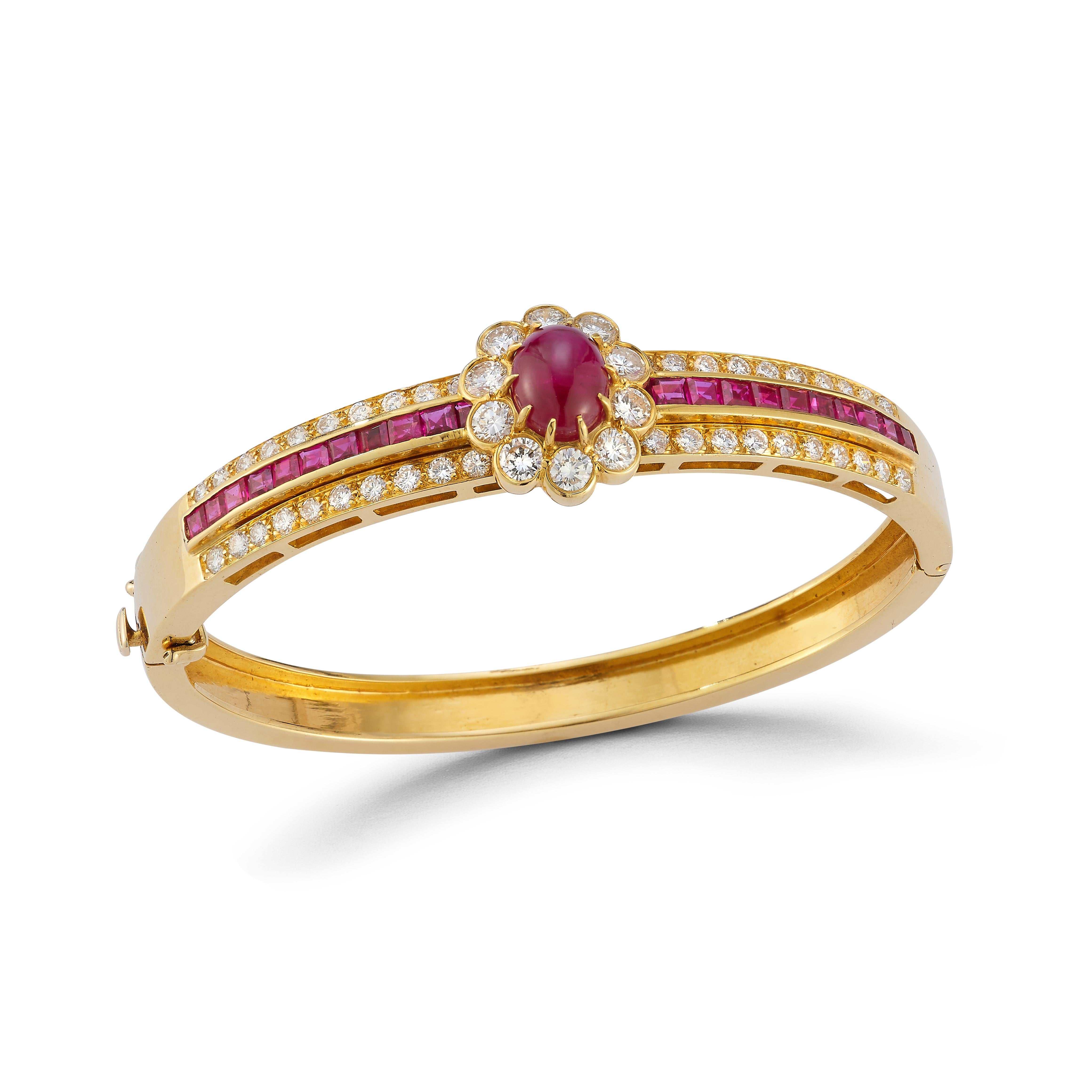 Van Cleef & Arpels Cabochon Ruby & Diamond Bangle Bracelet

A bracelet showcasing a center cabochon ruby encircled by round-cut diamonds, creating a floral pattern  with a row of square-cut rubies surrounded by two rows of round-cut