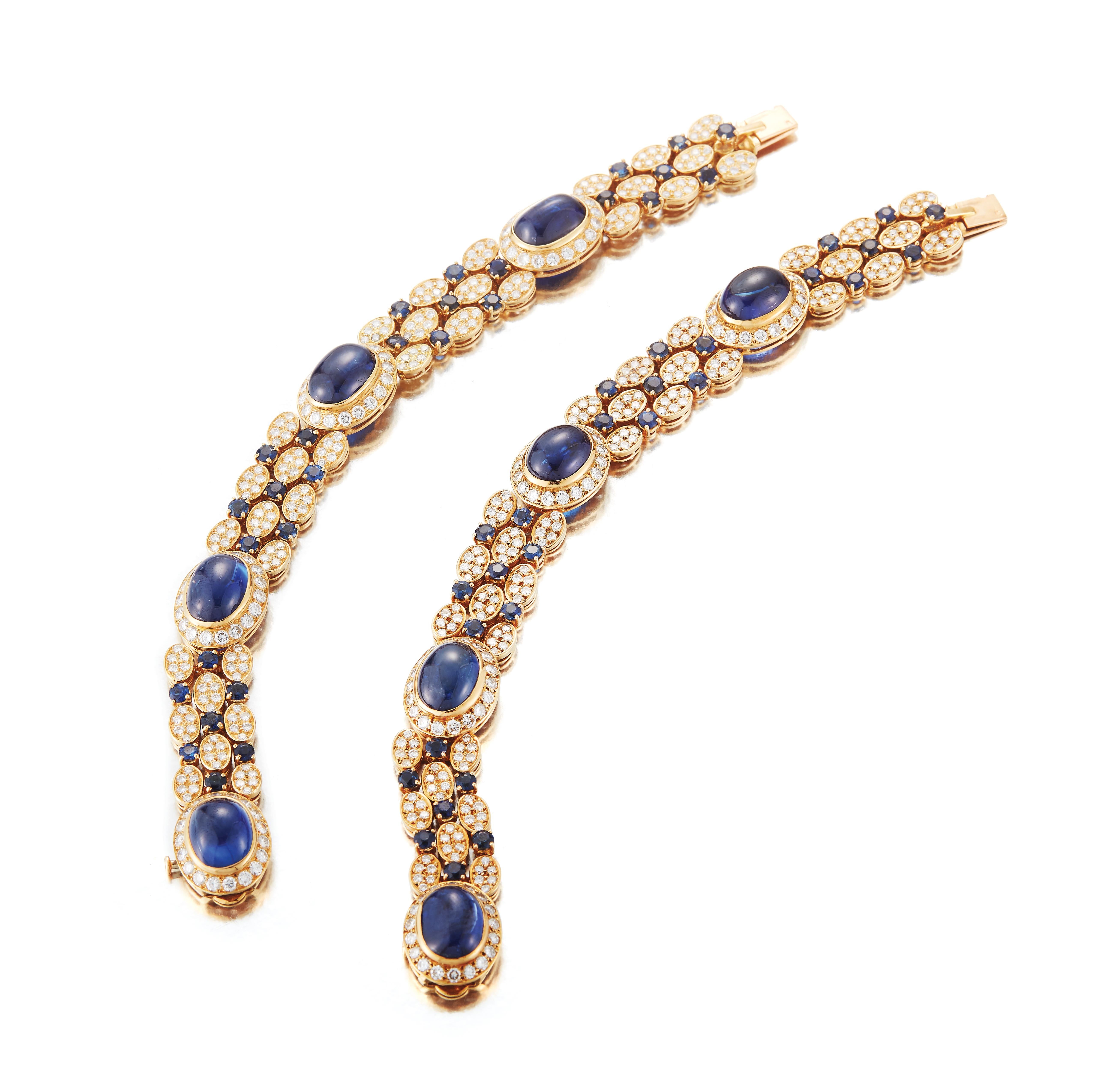 A gorgeous cabochon sapphire necklace and earring set. 

The stunningly long necklace which can be separated into two bracelets, showcases a unique layout of sapphires. 

Both necklace and earrings showcase tassels of fine diamonds and sapphires.