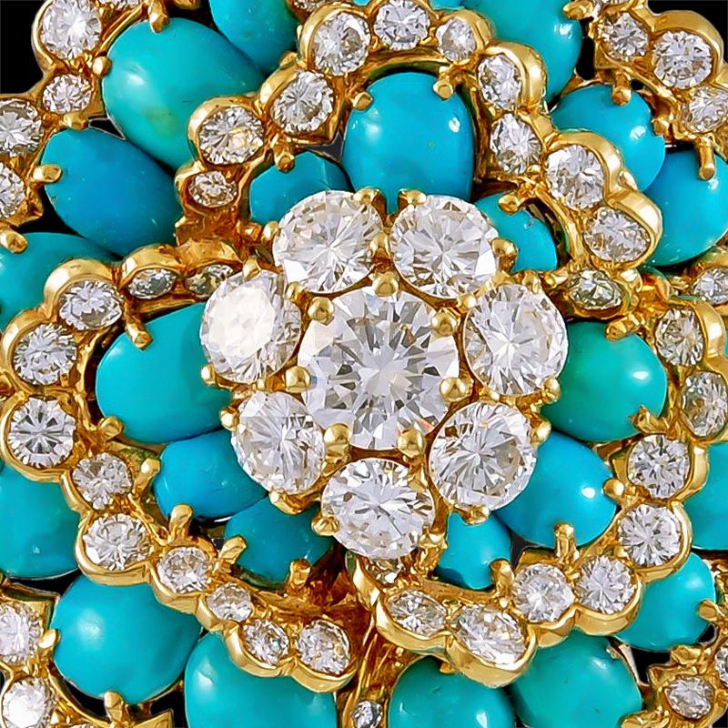 A  Van Cleef & Arpels  Camelia brooch from the 1960s, designed as a Camelia flower set with brilliant diamonds and the finest cabochon turquoise mounted in 18k yellow gold.  
The dimensions measure approximately 1 1/2″ x 1 1/2.”
Signed Van Clef &