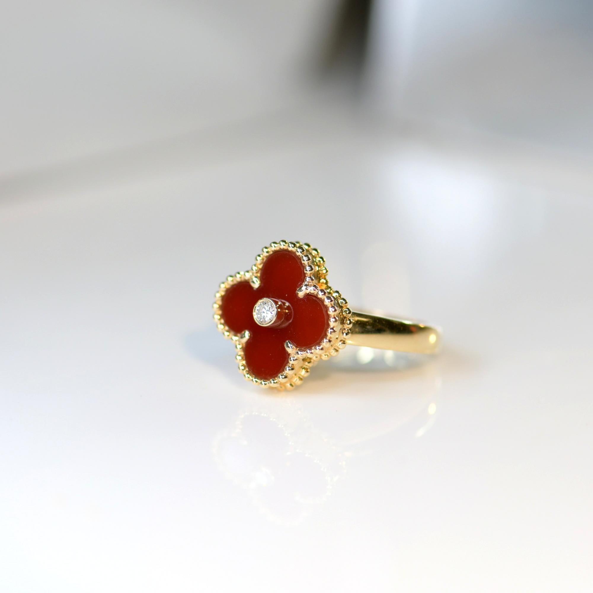 The iconic Alhambra Van Cleef & Arpels Alhambra carnelian diamond ring. The iconic clover leaf design is comprised of  a warm red carnelian, creating a soft glow against your ring.

This is the kind of piece that will become a staple of your