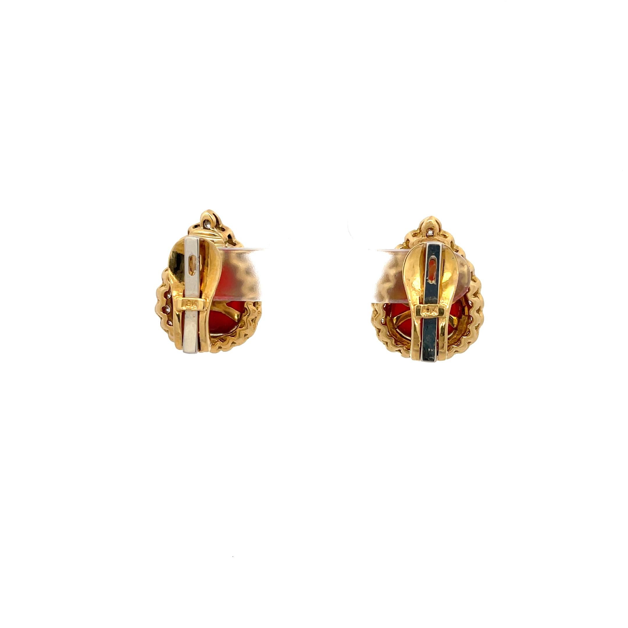 Van Cleef & Arpels Carnelian and Diamond Earrings in 18K Yellow Gold. The earrings feature two tear drop shape carnelians measuring 14.60 x 11.20, accented by a halo of brilliant round diamonds approximately 0.85ctw.  The earrings measure 1 x 0.50