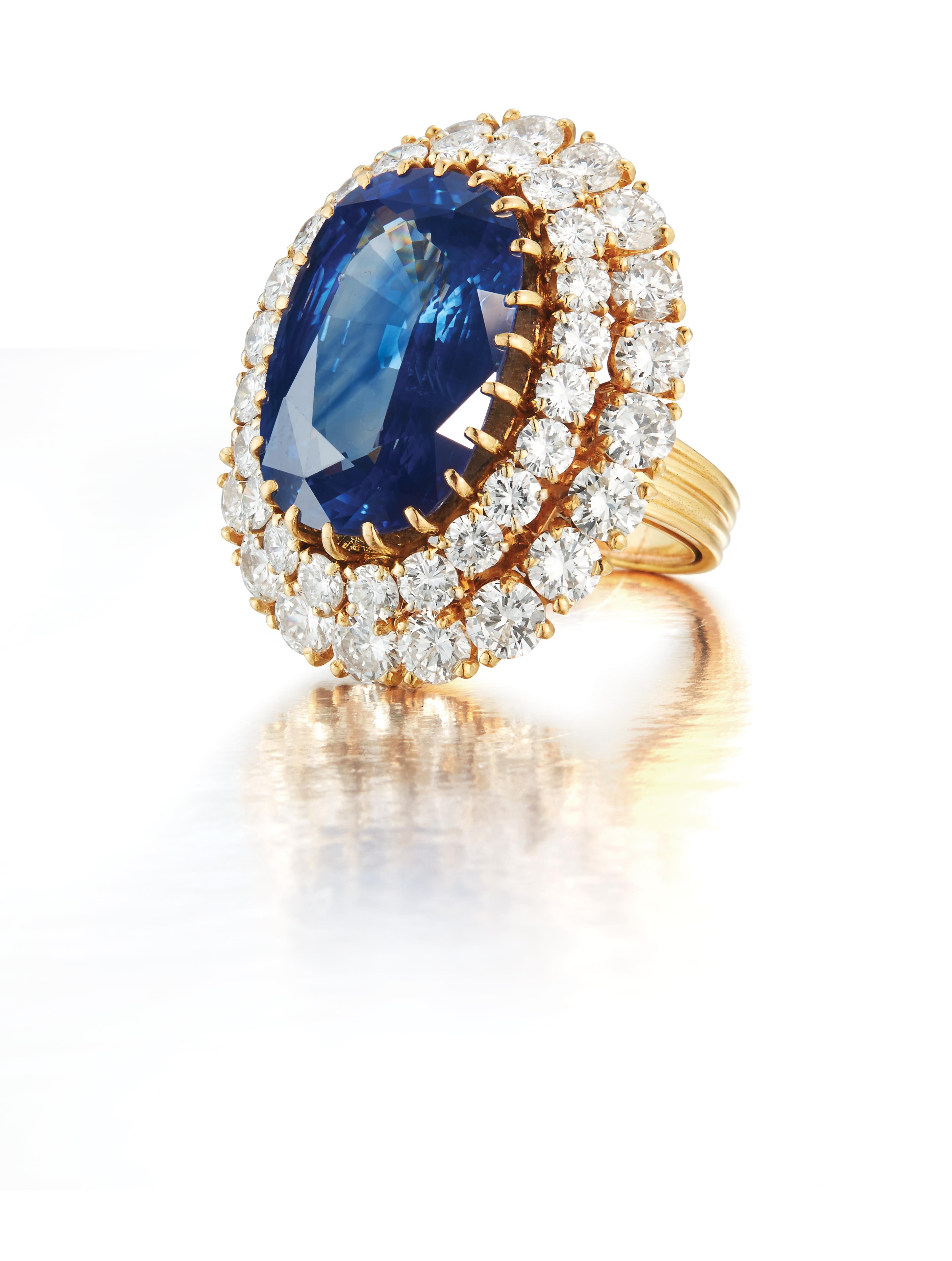 Van Cleef & Arpels Natural Certified Sapphire & Diamond Ring

An 18 karat gold ring set with a oval cut heated Ceylon sapphire weighing approximately 15 carats encircled by 42 round cut diamonds

Signed VCA and numbered
Accompanied by an AGL