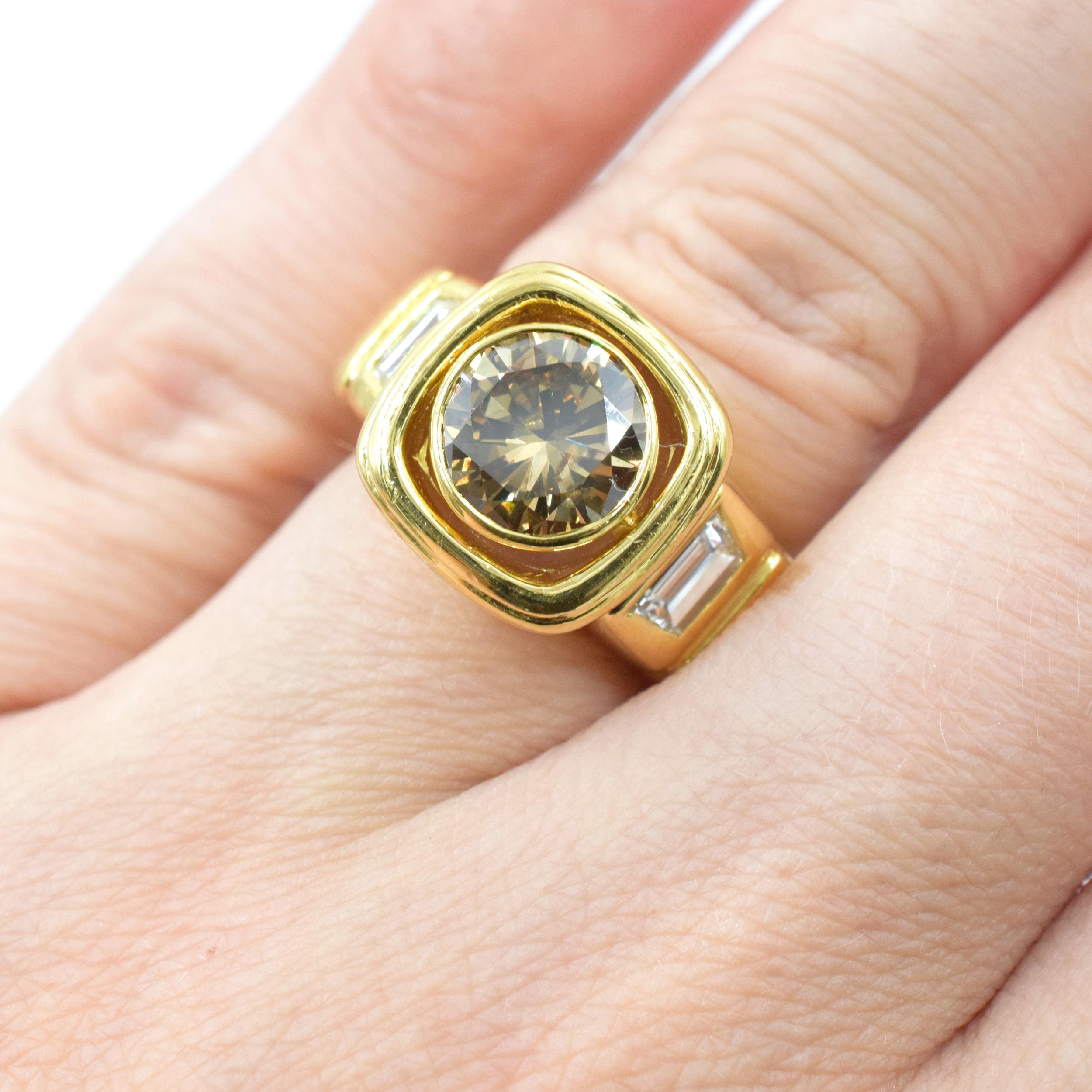 Van Cleef & Arpels champagne and white color diamond ring in 18k yellow gold. Center of this substantial ring is bezel set with round brilliant cut champagne color diamond with a weight of approximately 2.0 carats accented by yellow gold cushion