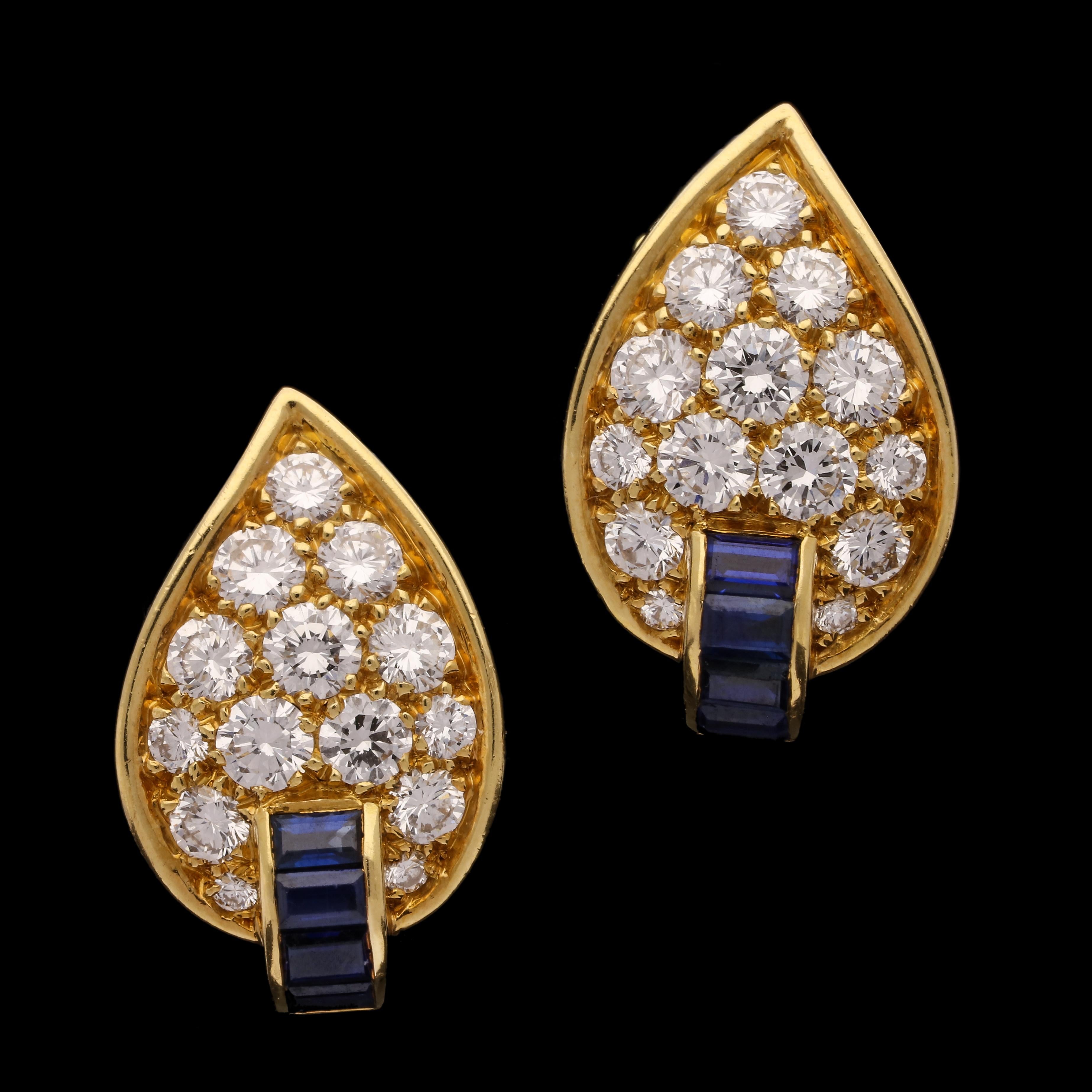 An elegant pair of vintage diamond and sapphire leaf earrings by Van Cleef & Arpels c.1970s, each designed as an asymmetric curved leaf with pointed tip and pavé set throughout with round brilliant cut diamonds, the stalk set with baguette sapphires