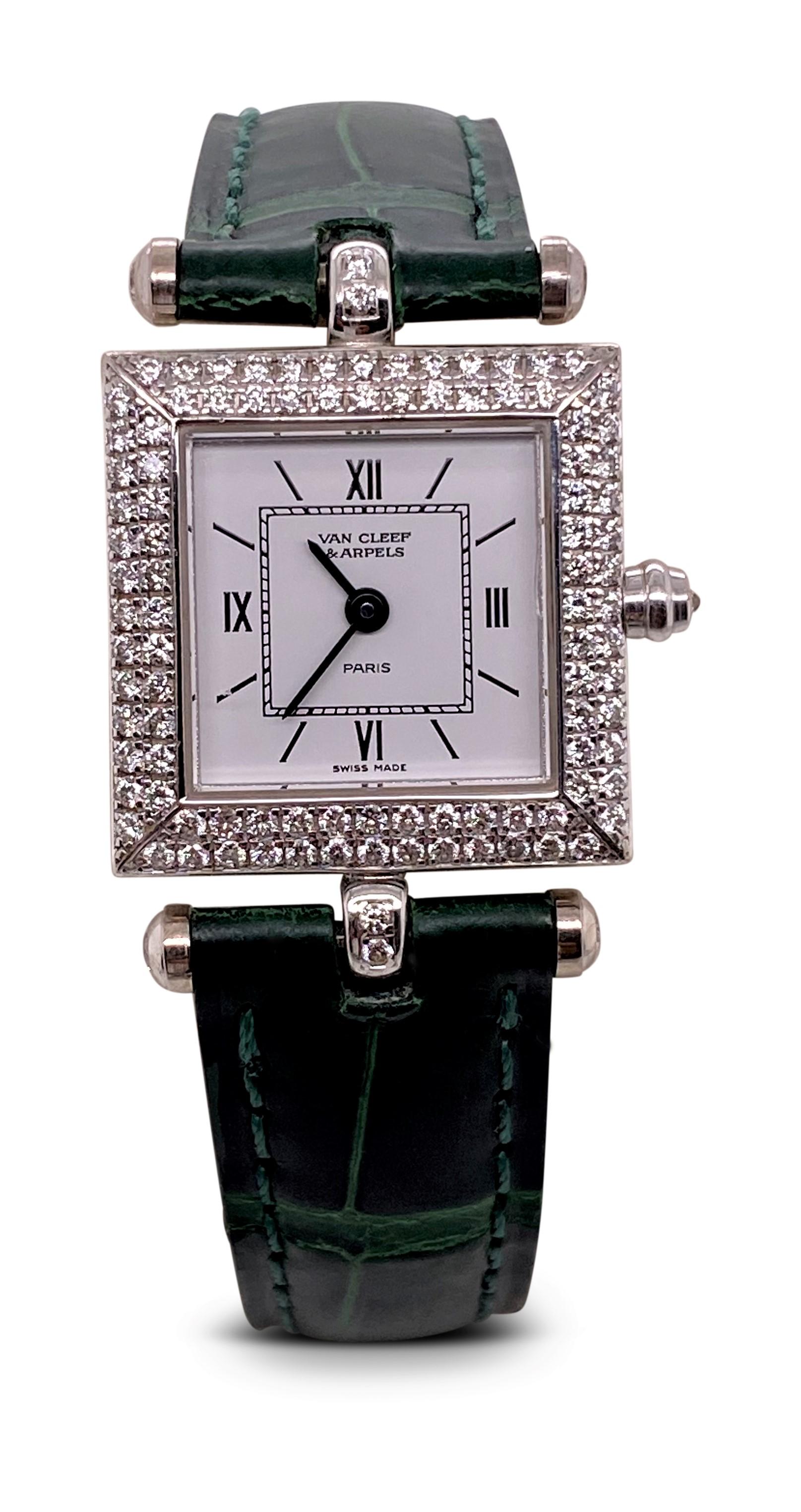 Authentic Van Cleef & Arpels 'Classique' watch crafted in 18 karat white gold with a double row diamond bezel. The rectangular watch case measures 20 x 20 mm without lugs. Both the watch bezel and lugs are set with an estimated 1.05 carats of round