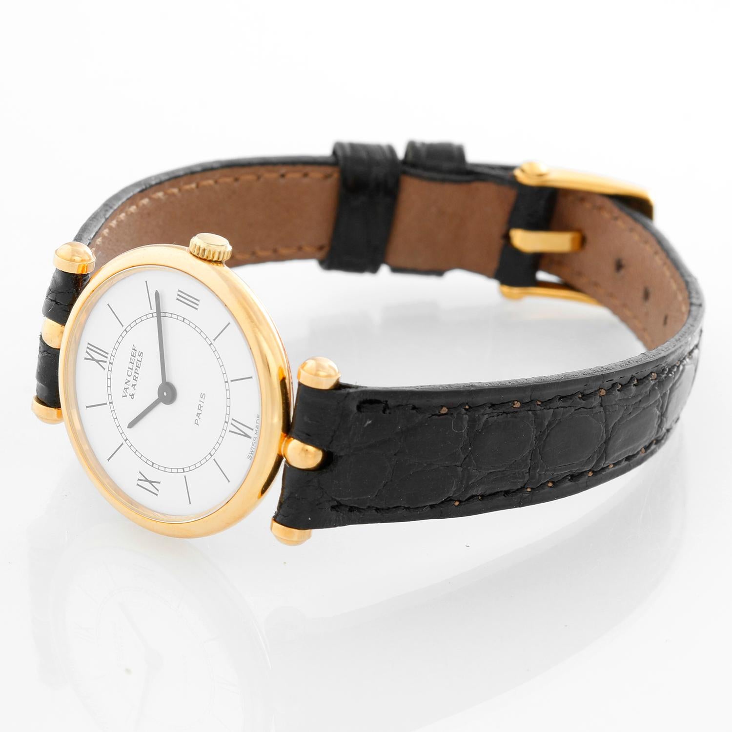 Van Cleef & Arpels Classique Ladies Watch - Quartz. 14K Yellow Gold ( 24 mm ). Flat white dial with stick hour markers and Roman numeral markers at 12, 3, 6, and 9 o'clock. Alligator strap with  Van Cleef & Arpels tang buckle. Pre-owned with custom