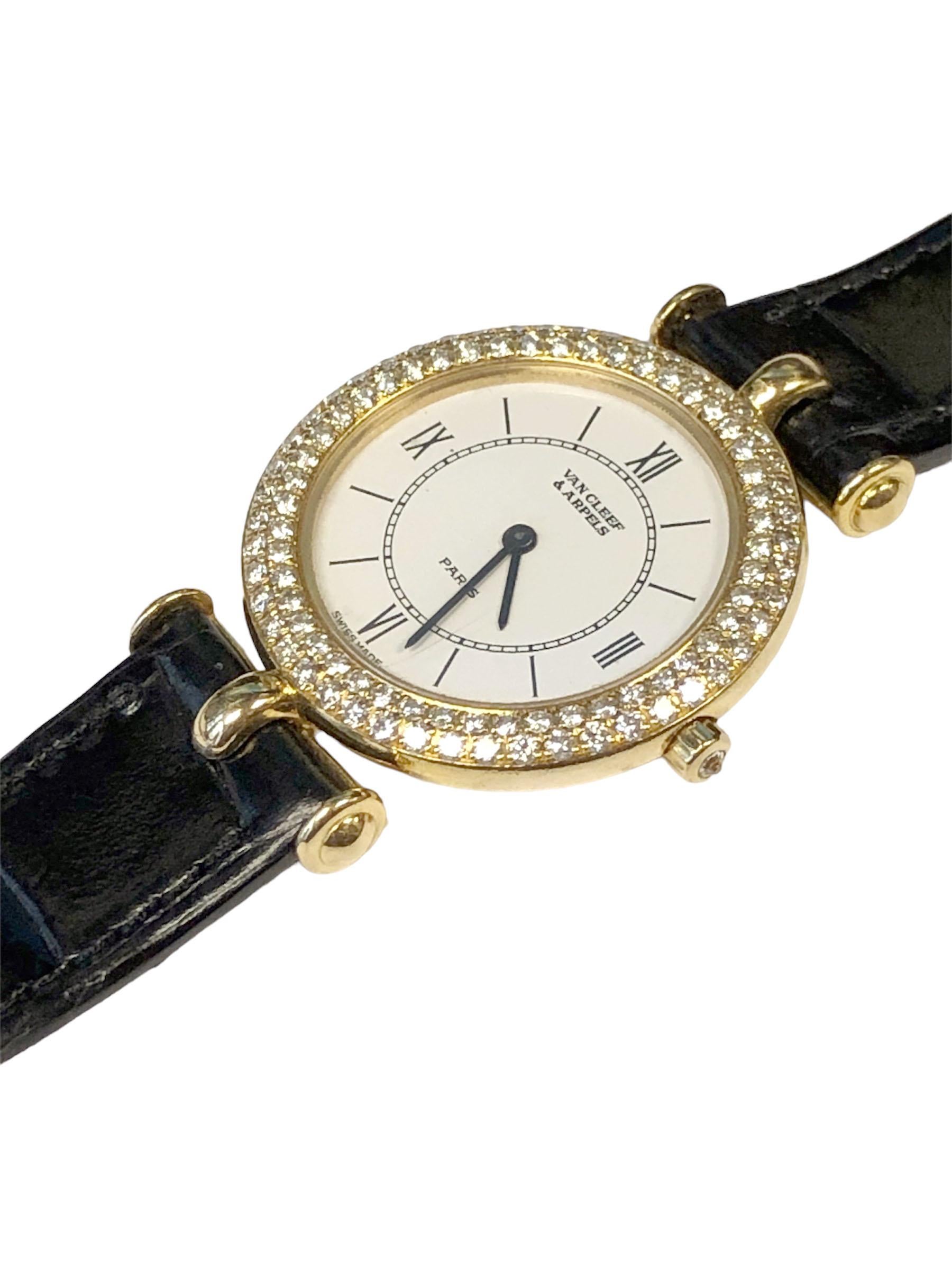 Circa 1990s Van Cleef & Arpels Classique Collection Ladies Wrist Watch, 27 M.M. 2 piece 18k Yellow Gold case with double row Round Brilliant cut Diamond Bezel totaling just over one Carat. Quartz Movement, White dial with Black Roman Numerals. New