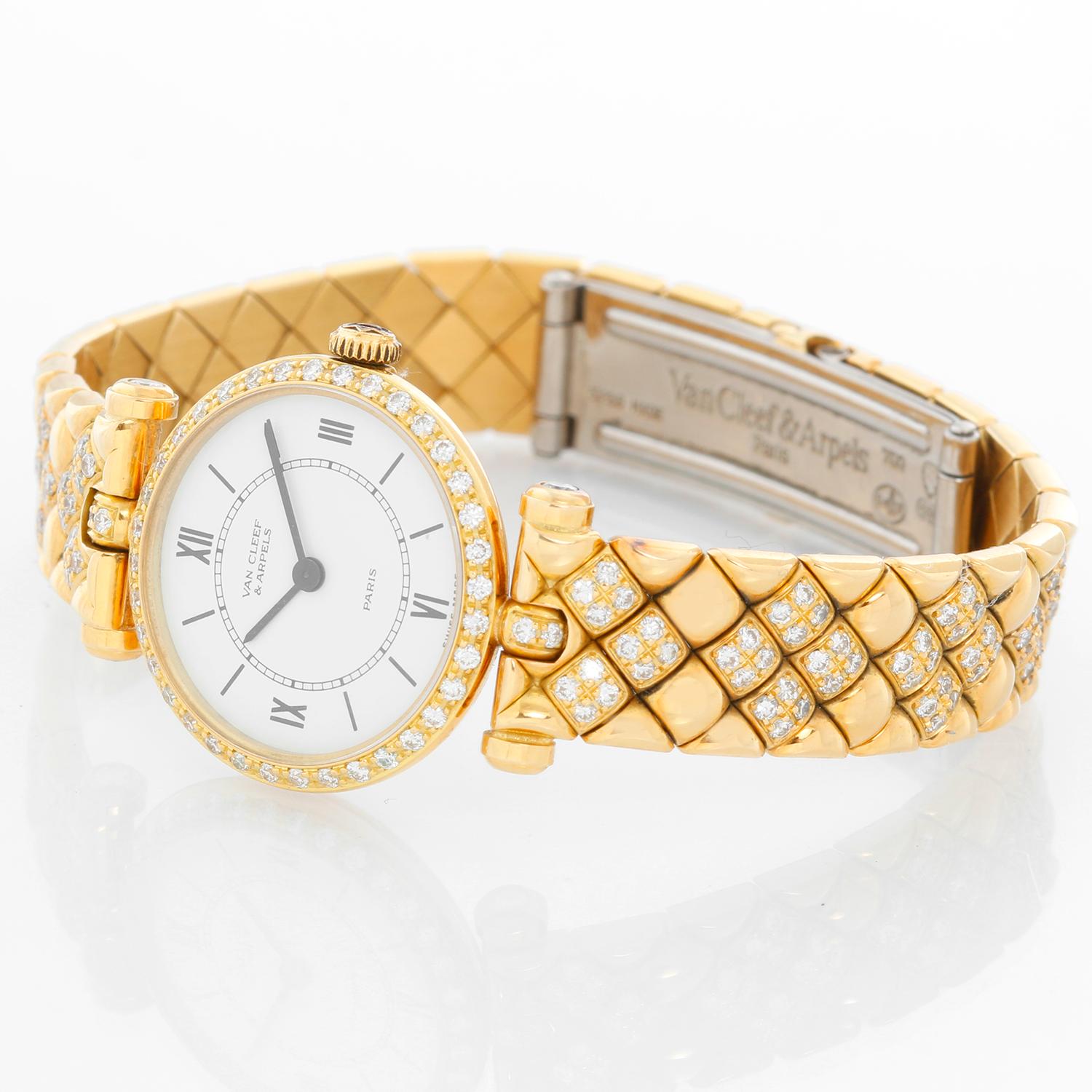 Van Cleef & Arpels Classique Paris Ladies Watch 18901B1 - Quartz. 18K Yellow gold with diamond bezel ( 20mm ). White dial with black numerals. 18K Yellow gold diamond bracelet with double deployant buckle; Will fit up to a 5 3/4 inch wrist.