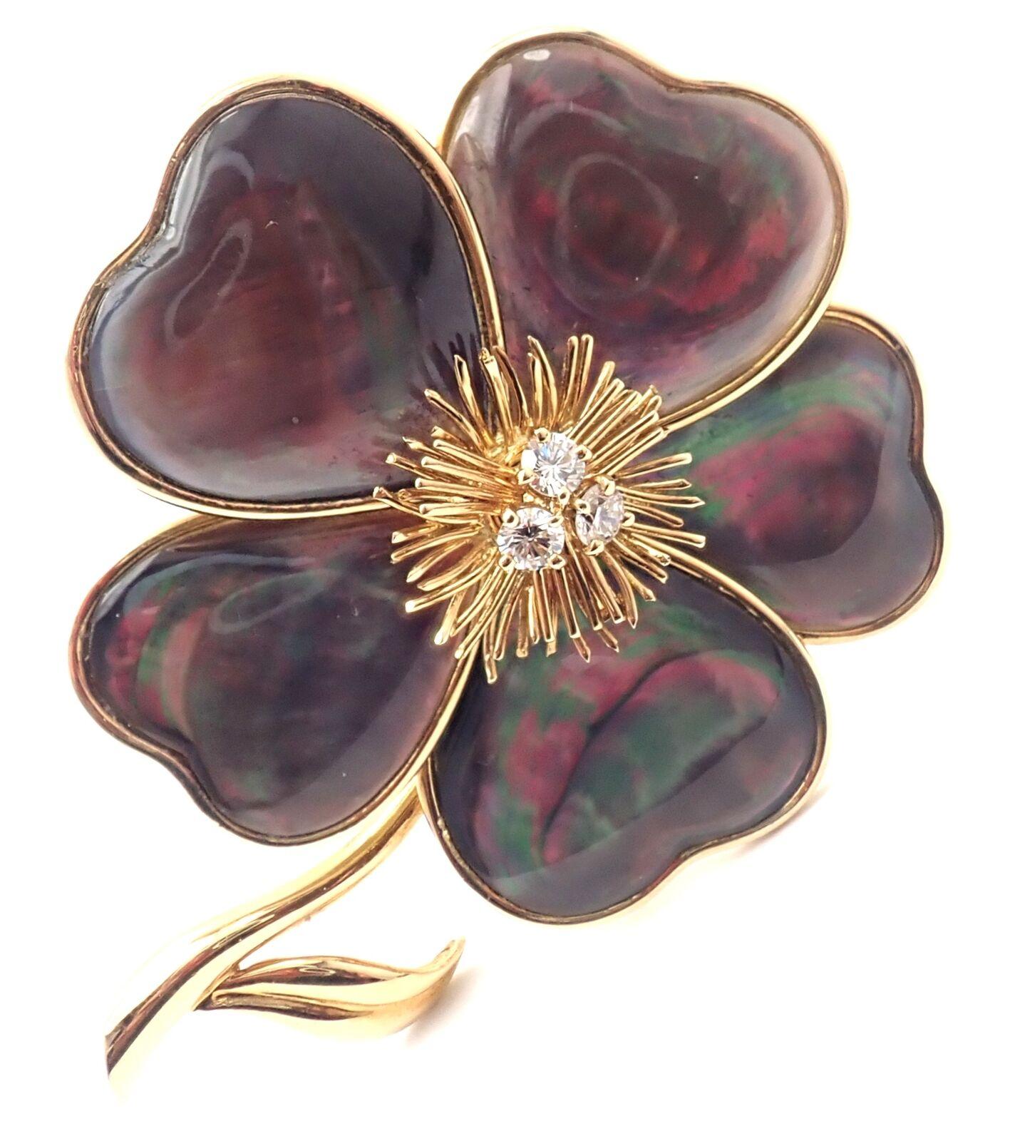 18k Yellow Gold Clématite Flower Diamond Gray Mother Of Pearl Brooch by Van Cleef & Arpels.
This brooch comes with service paper from VCA store in New York and a VCA box.
With 3 round brilliant cut diamonds VVS1 clarity, E color total weight approx.