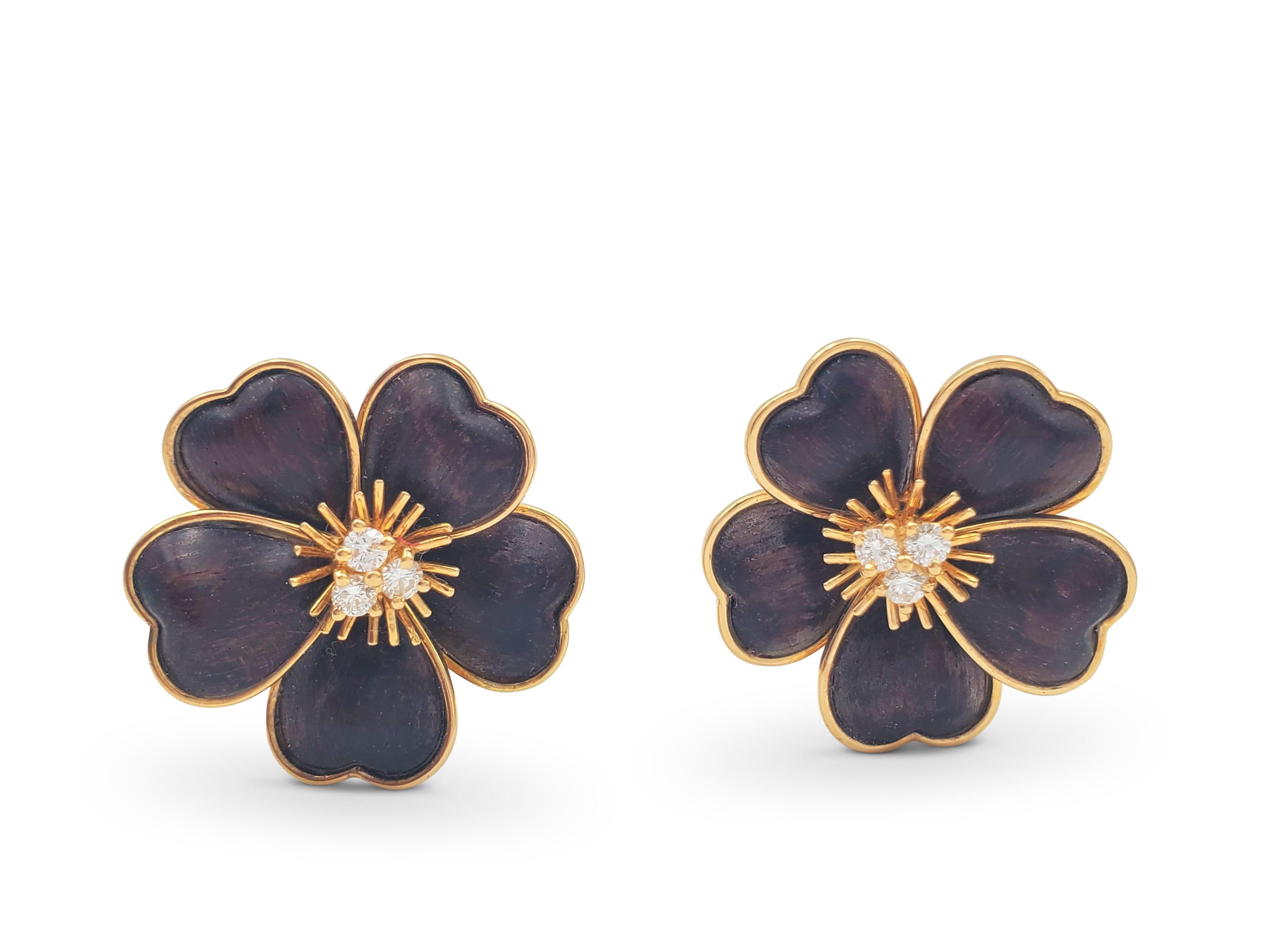 Authentic pair of Van Cleef & Arpels Clématite earrings. Each earring designed as a clematis flower with a center set with brilliant-cut diamonds (E-F color, VS clarity) weighing an estimated 0.30 carats on spiked gold filaments. The carved bois